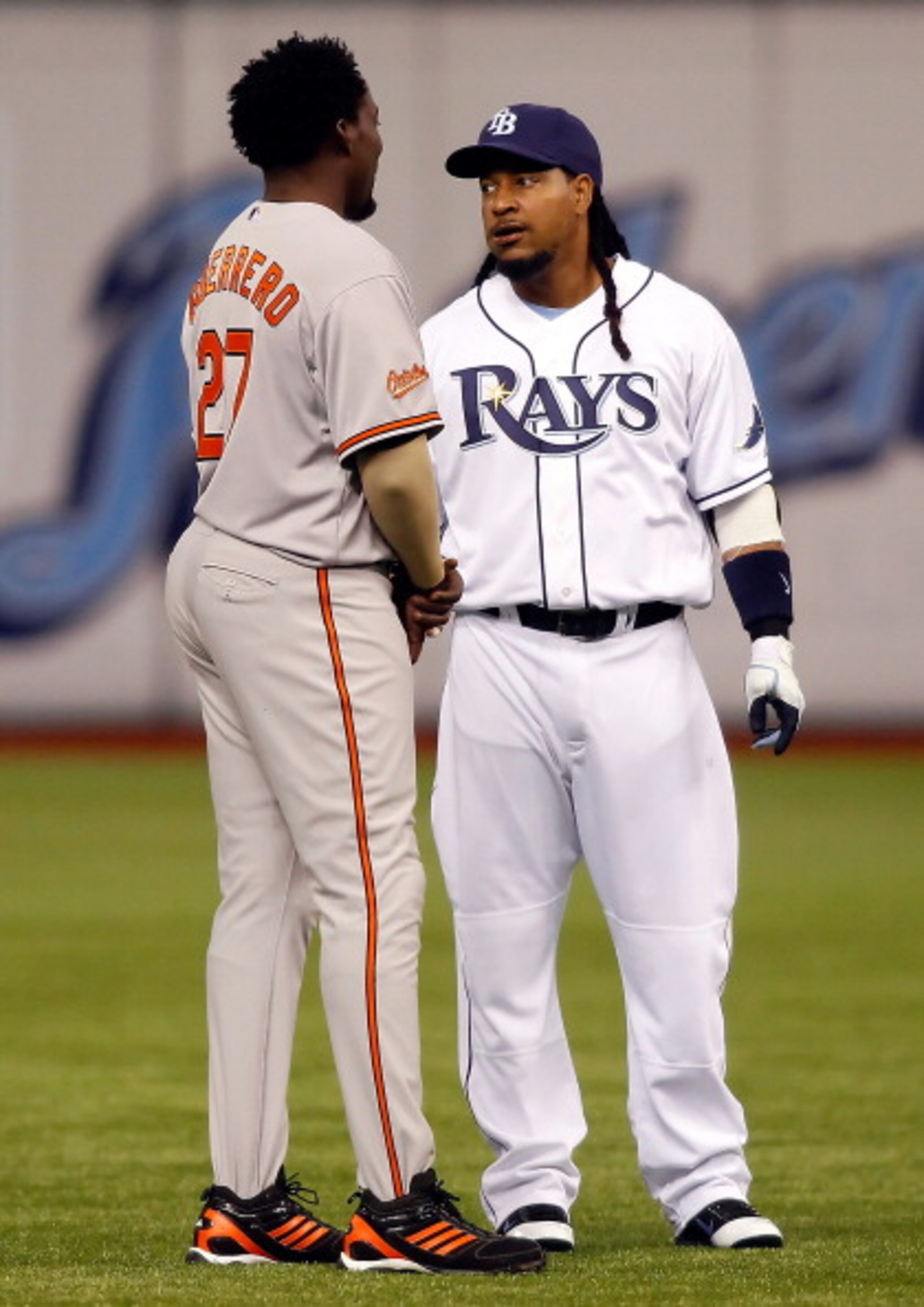 ST. PETERSBURG, FL - APRIL 02:  Designated hitter Manny Ramirez #24 of the Tampa Bay Rays talks with designated hitter Vladimir Guerrero #27 of the Baltimore Orioles just before the start of the game at Tropicana Field on April 2, 2011 in St. Petersburg, 