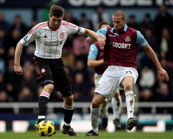 LONDON, ENGLAND - FEBRUARY 27:  Steven Gerrard of Liverpool is challenged by Matthew Upson of West Ham during the Barclays Premier League match between West Ham United and Liverpool at the Boleyn Ground on February 27, 2011 in London, England.  (Photo by
