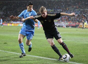 PORT ELIZABETH, SOUTH AFRICA - JULY 10:  Luis Suarez of Uruguay tussles for posession with Toni Kroos of Germany during the 2010 FIFA World Cup South Africa Third Place Play-off match between Uruguay and Germany at The Nelson Mandela Bay Stadium on July 1