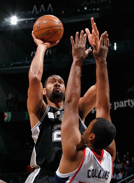 ATLANTA, GA - APRIL 05:  Tim Duncan #21 of the San Antonio Spurs shoots against Jason Collins #34 of the Atlanta Hawks at Philips Arena on April 5, 2011 in Atlanta, Georgia.  NOTE TO USER: User expressly acknowledges and agrees that, by downloading and/or