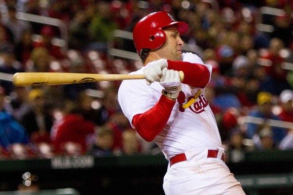 ST. LOUIS, MO - APRIL 4: Lance Berkman #12 of the St. Louis Cardinals hits an RBI single against the Pittsburgh Pirates at Busch Stadium on April 4, 2011 in St. Louis, Missouri.  (Photo by Dilip Vishwanat/Getty Images)