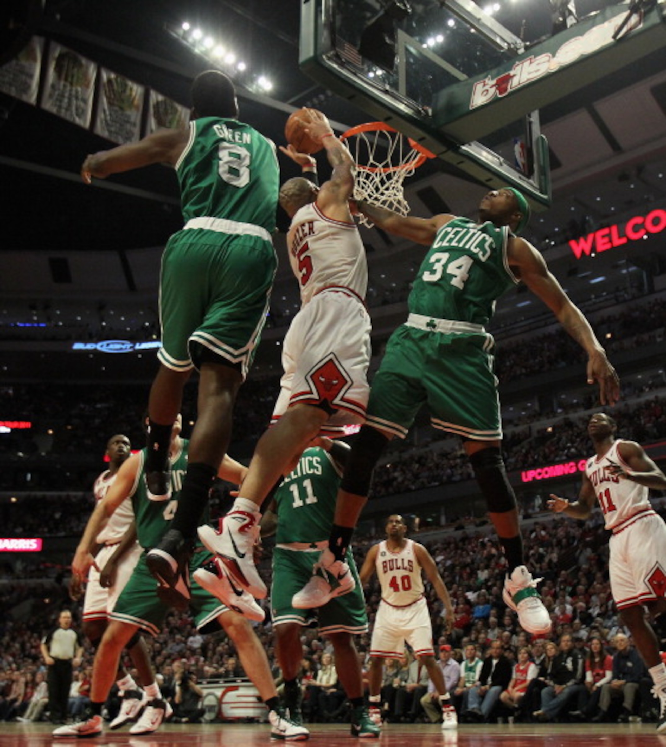 CHICAGO, IL - APRIL 07: Carlos Boozer #5 of the Chicago Bulls puts up a shot between Jeff Green #8 and Paul Pierce #34 of the Boston Celtics at United Center on April 7, 2011 in Chicago, Illinois. The Bulls defeated the Celtics 97-81. NOTE TO USER: User e CHICAGO, IL - APRIL 07: Carlos Boozer #5 of the Chicago Bulls puts up a shot between Jeff Green #8 and Paul Pierce #34 of the Boston Celtics at United Center on April 7, 2011 in Chicago, Illinois. The Bulls defeated the Celtics 97-81. NOTE TO USER: User e