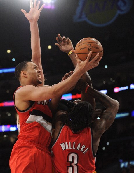 LOS ANGELES, CA - MARCH 20:  Brandon Roy #7 of the Portland Trail Blazers scores on a layup as he collides with Gerald Wallace #3 against the Los Angeles Lakers at the Staples Center on March 20, 2011 in Los Angeles, California.  NOTE TO USER: User expres