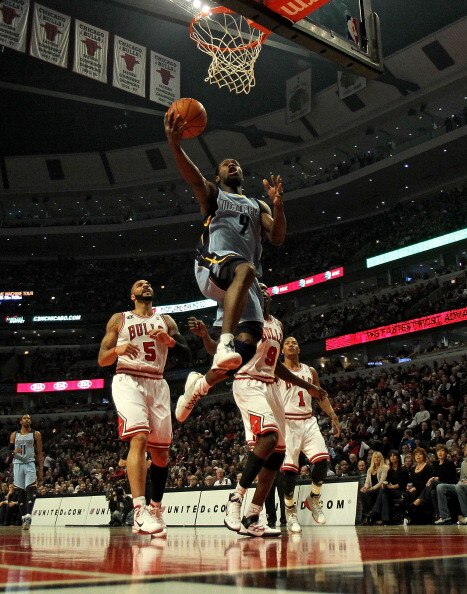 CHICAGO, IL - MARCH 25: Tony Allen #9 of the Memphis Girzzlies drives to the basket past Carlos Boozer #5 (L) and Loul Deng #9 of the Chicago Bulls at the United Center on March 25, 2011 in Chicago, Illinois. NOTE TO USER: User expressly acknowledges and