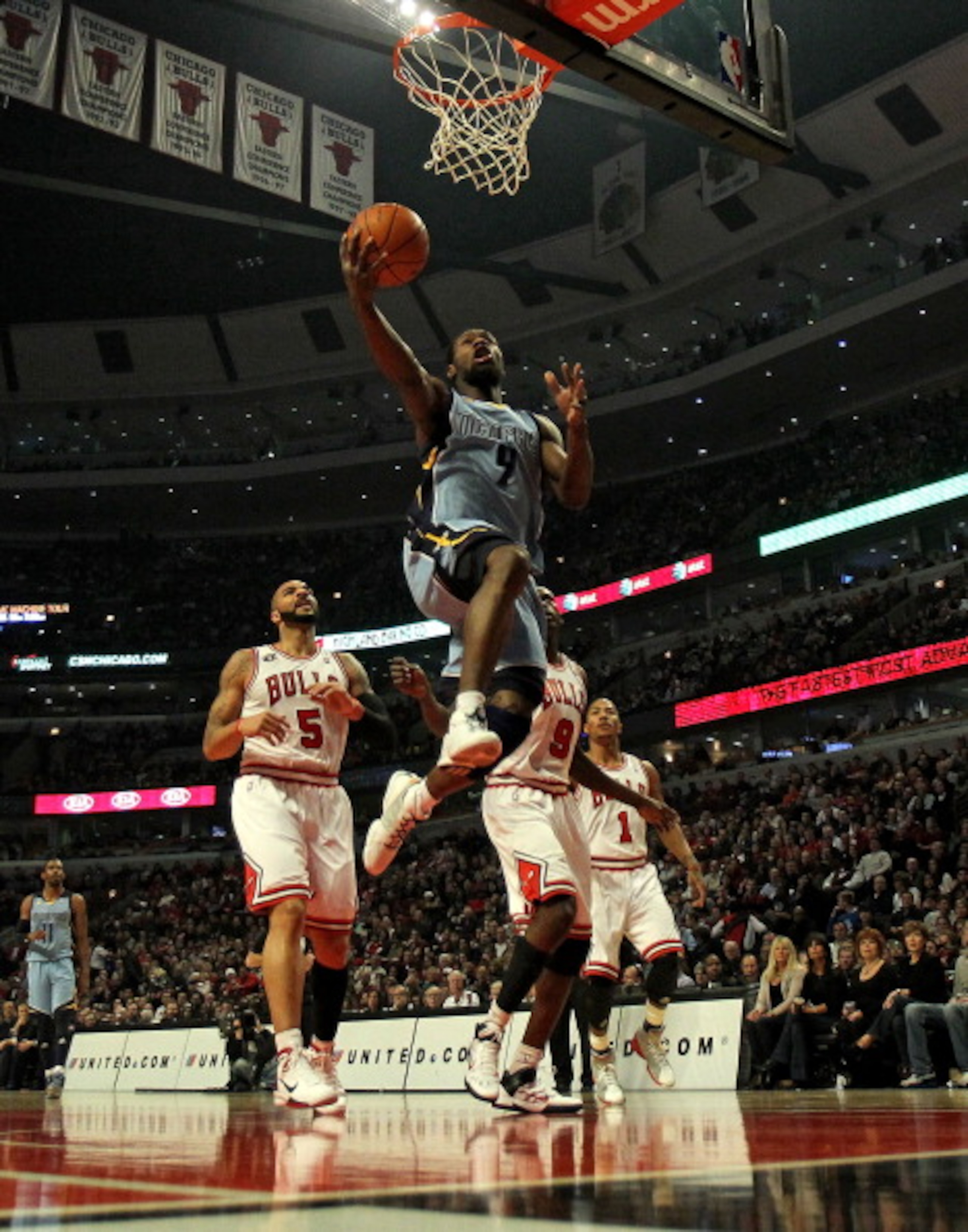 CHICAGO, IL - MARCH 25: Tony Allen #9 of the Memphis Girzzlies drives to the basket past Carlos Boozer #5 (L) and Loul Deng #9 of the Chicago Bulls at the United Center on March 25, 2011 in Chicago, Illinois. NOTE TO USER: User expressly acknowledges and CHICAGO, IL - MARCH 25: Tony Allen #9 of the Memphis Girzzlies drives to the basket past Carlos Boozer #5 (L) and Loul Deng #9 of the Chicago Bulls at the United Center on March 25, 2011 in Chicago, Illinois. NOTE TO USER: User expressly acknowledges and