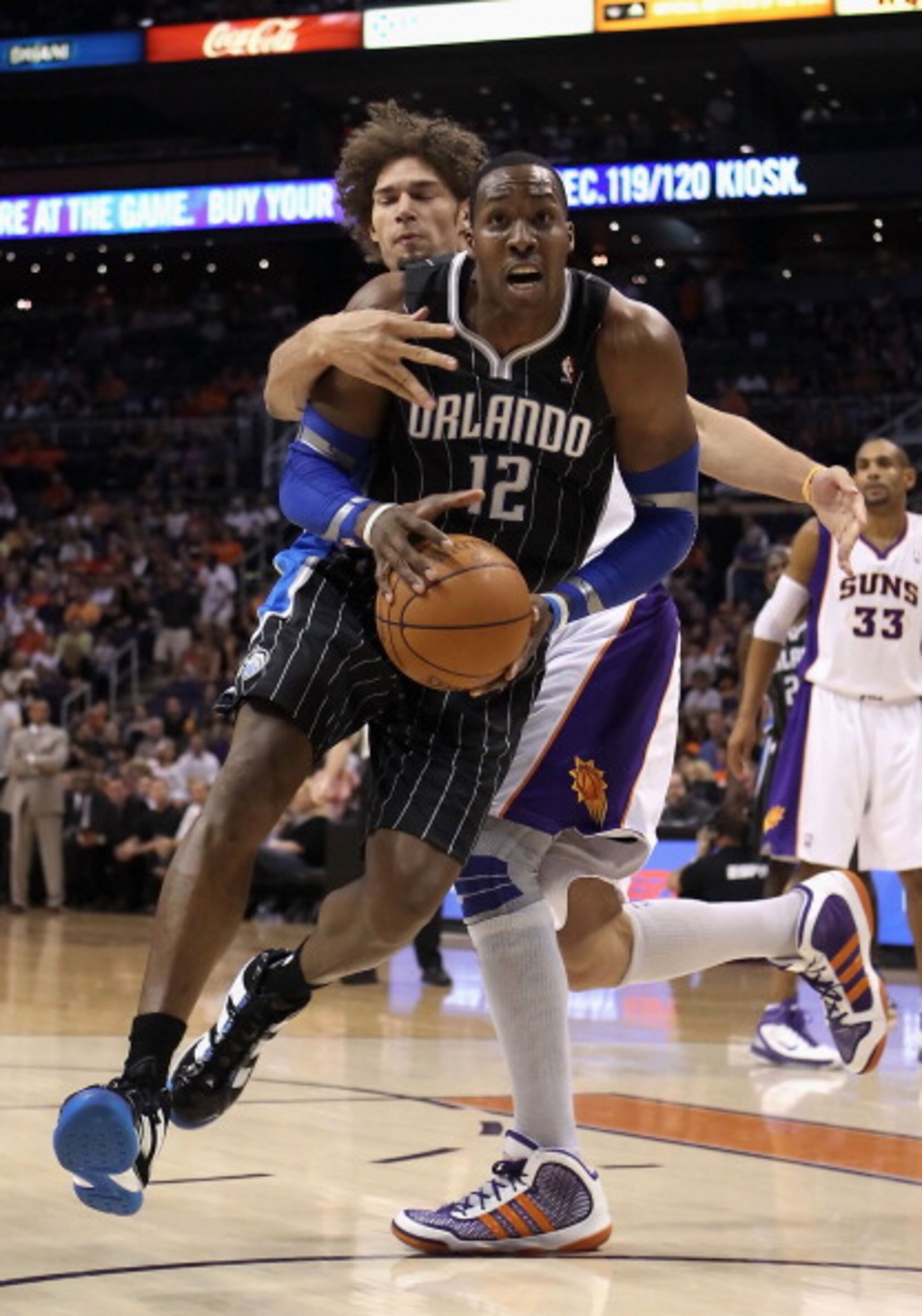 PHOENIX, AZ - MARCH 13: Dwight Howard #12 of the Orlando Magic drives to the basket during the NBA game against the Phoenix Suns at US Airways Center on March 13, 2011 in Phoenix, Arizona. The Magic defeated the Suns 111-88. NOTE TO USER: User expressly PHOENIX, AZ - MARCH 13: Dwight Howard #12 of the Orlando Magic drives to the basket during the NBA game against the Phoenix Suns at US Airways Center on March 13, 2011 in Phoenix, Arizona. The Magic defeated the Suns 111-88. NOTE TO USER: User expressly