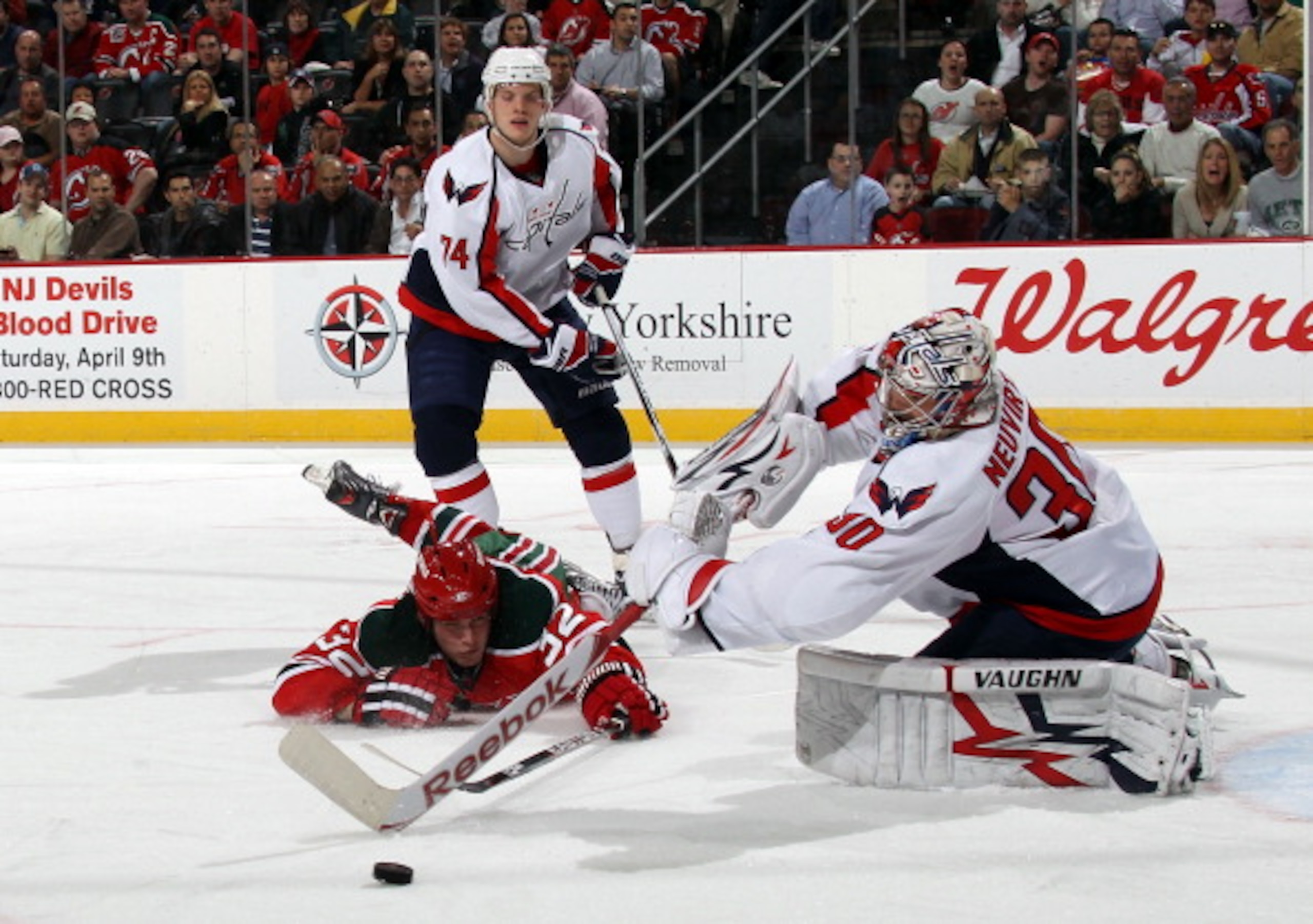 NEWARK, NJ - MARCH 18: Michal Neuvirth #30 of the Washington Capitals shoots the puck away from Nick Palmieri #32 of the New Jersey Devils at the Prudential Center on March 18, 2011 in Newark, New Jersey. (Photo by Bruce Bennett/Getty Images) NEWARK, NJ - MARCH 18: Michal Neuvirth #30 of the Washington Capitals shoots the puck away from Nick Palmieri #32 of the New Jersey Devils at the Prudential Center on March 18, 2011 in Newark, New Jersey. (Photo by Bruce Bennett/Getty Images)