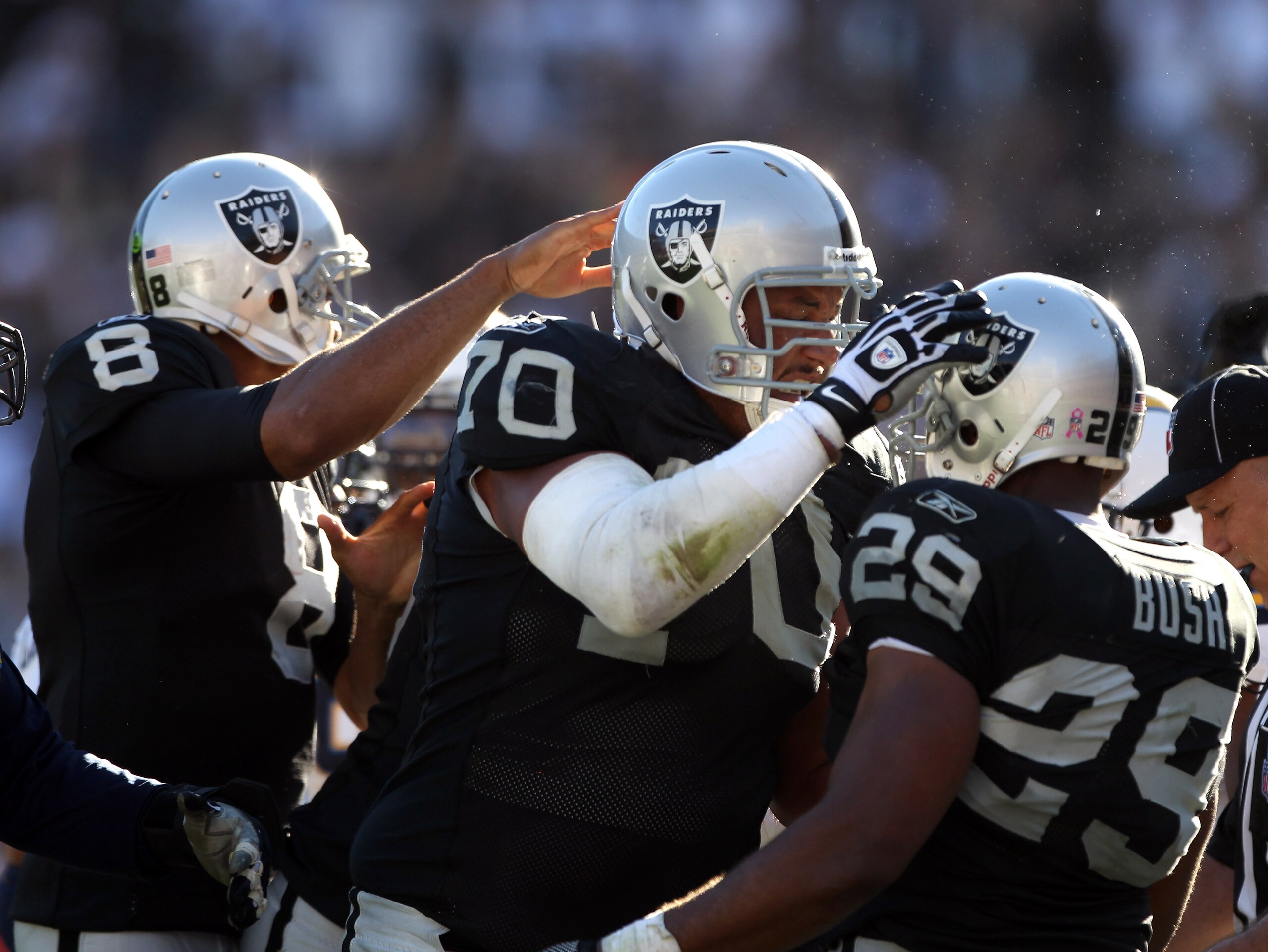 OAKLAND, CA - OCTOBER 10:  Michael Bush #29 is congratulated by Langston Walker #70 and Jason Campbell #8 of the Oakland Raiders after Bush scored a touchdwon against the San Diego Chargers at Oakland-Alameda County Coliseum on October 10, 2010 in Oakland