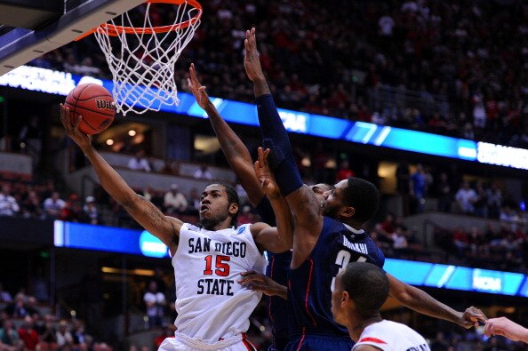 ANAHEIM, CA - MARCH 24:  Kawhi Leonard #15 of the San Diego State Aztecs goes to the hoop against Alex Oriakhi #34 of the Connecticut Huskies during the west regional semifinal of the 2011 NCAA men's basketball tournament at the Honda Center on March 24, 