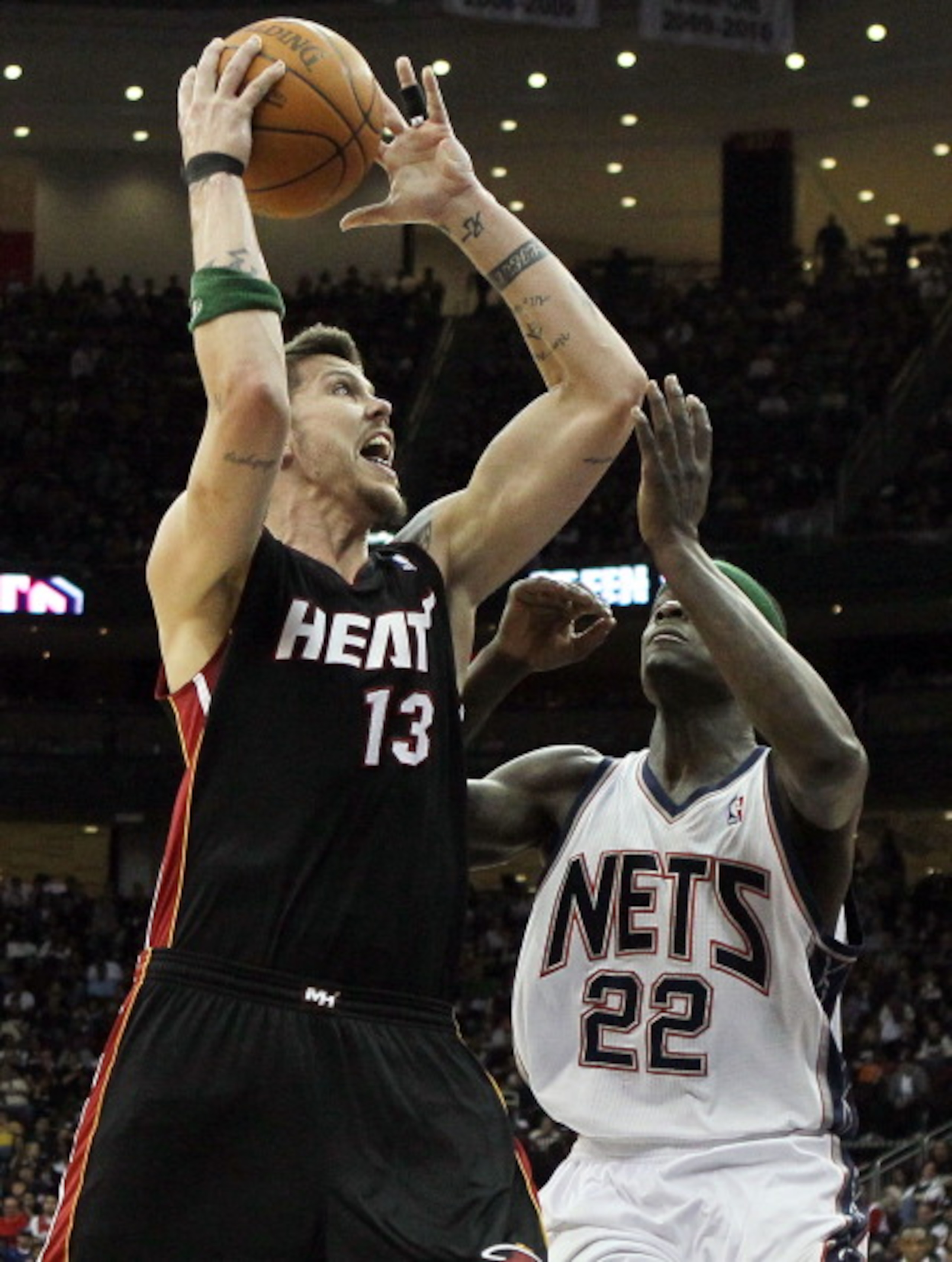 NEWARK, NJ - APRIL 03:  Mike Miller #13 of the Miami Heat puts up a shot against Anthony Morrow #22 of the New Jersey Nets at the Prudential Center on April 3, 2011 in Newark, New Jersey.NOTE TO USER: User expressly acknowledges and agrees that, by downlo