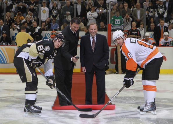 PITTSBURGH - OCTOBER 07:  Team owner Mario Lemieux of the Pittsburgh Penguins drops the puck between Sidney Crosby #87 and Mike Richards #18 of the Philadelphia Flyers as NHL commissioner Gary Bettman looks on prior to the arena opening game  at the Conso