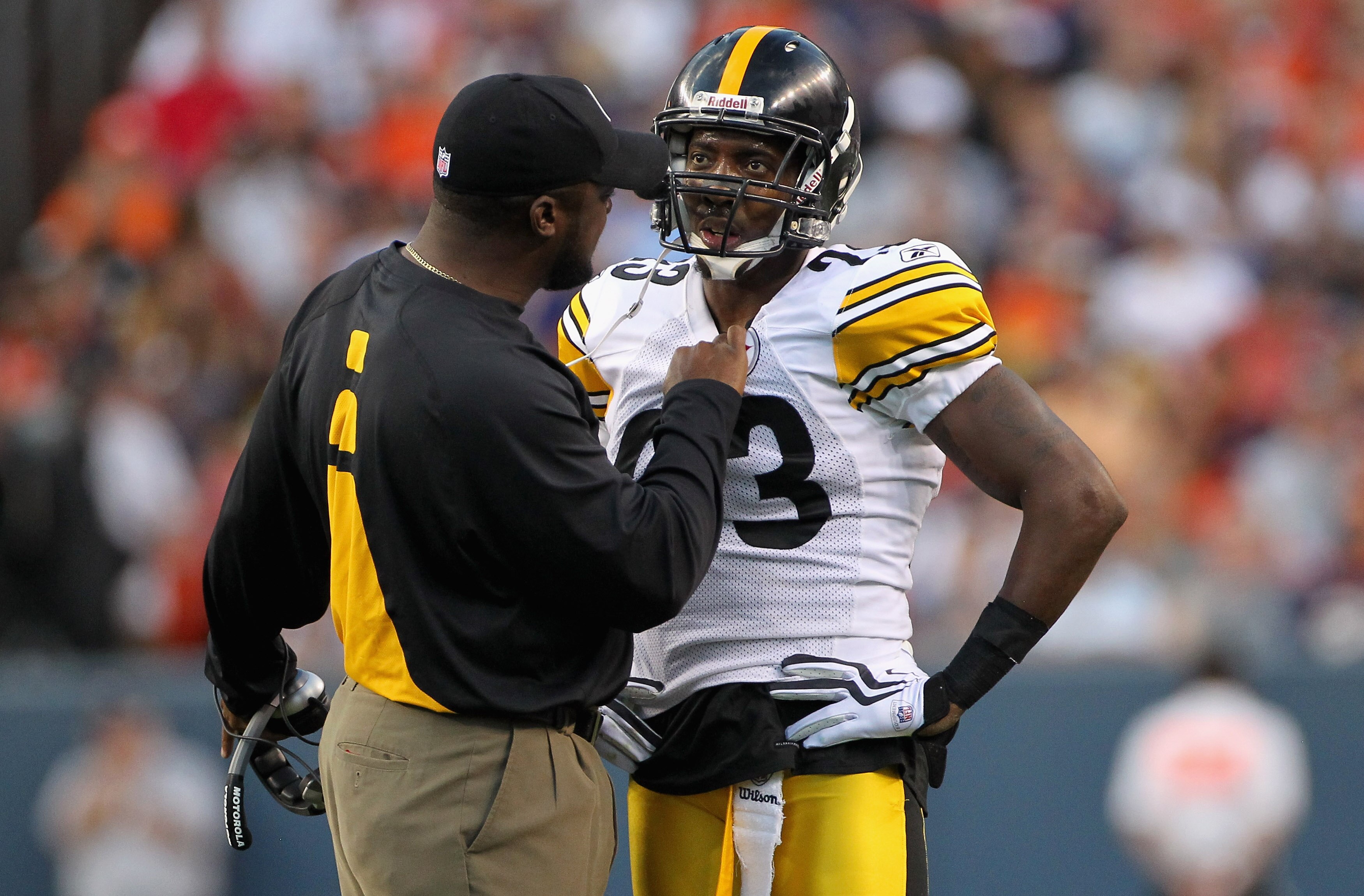 DENVER - AUGUST 29:  Head coach Mike Tomlin of the Pittsburgh Steelers has something to say to cornerback Keenan Lewis #23 after he was called for a personal foul as he tackled Brandon Lloyd of the Denver Broncos during preseason NFL action at INVESCO Fie