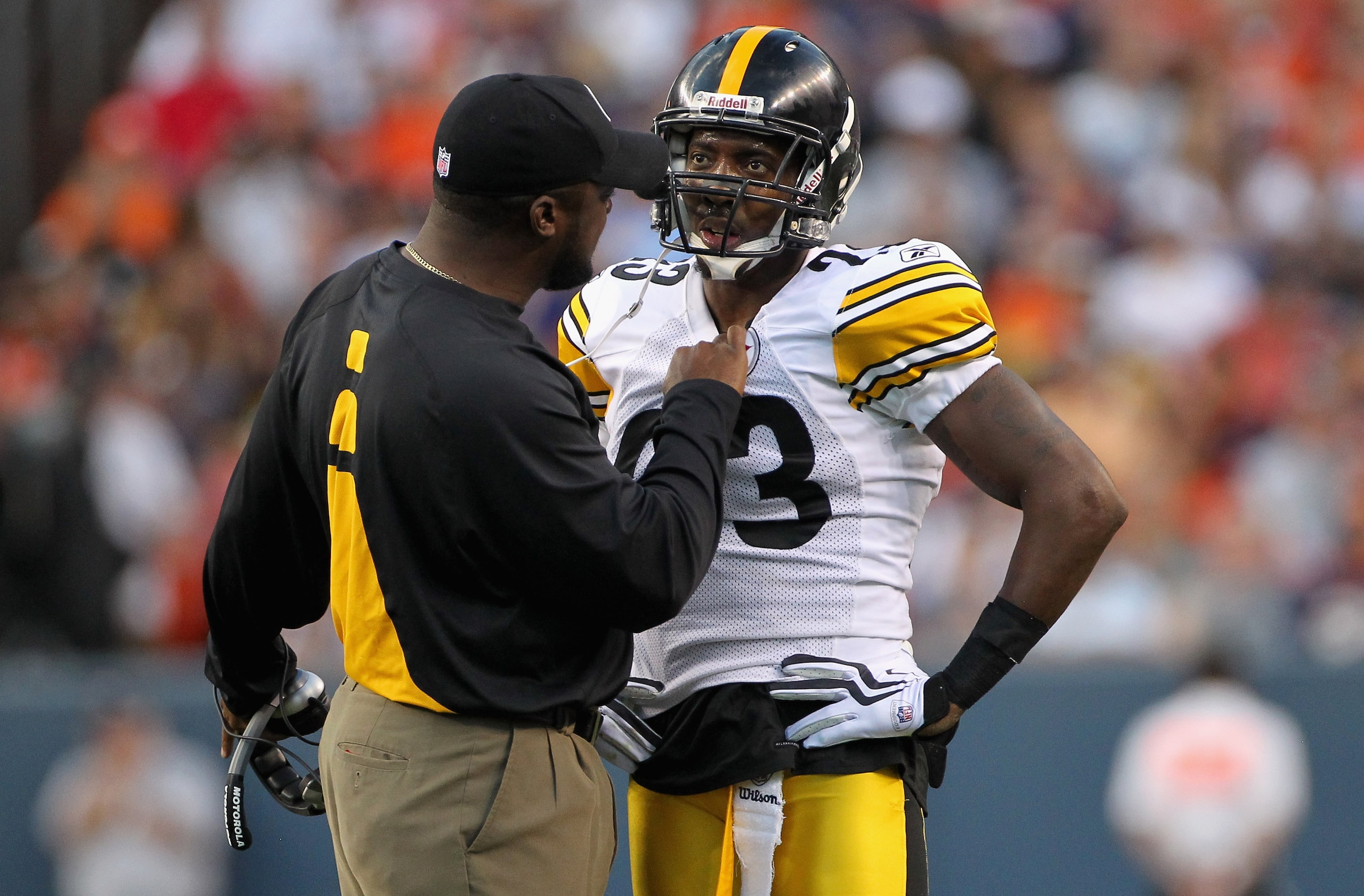 DENVER - AUGUST 29:  Head coach Mike Tomlin of the Pittsburgh Steelers has something to say to cornerback Keenan Lewis #23 after he was called for a personal foul as he tackled Brandon Lloyd of the Denver Broncos during preseason NFL action at INVESCO Fie