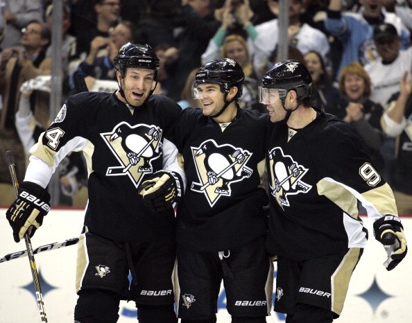 PITTSBURGH, PA - JANUARY 05:  Chris Kunitz #14 of the Pittsburgh Penguins celebrates his first period goal with Brooks Orpik #44 and Pascal Dupuis #9 against the Tampa Bay Lightning on January 5, 2011 at Consol Energy Center in Pittsburgh, Pennsylvania.