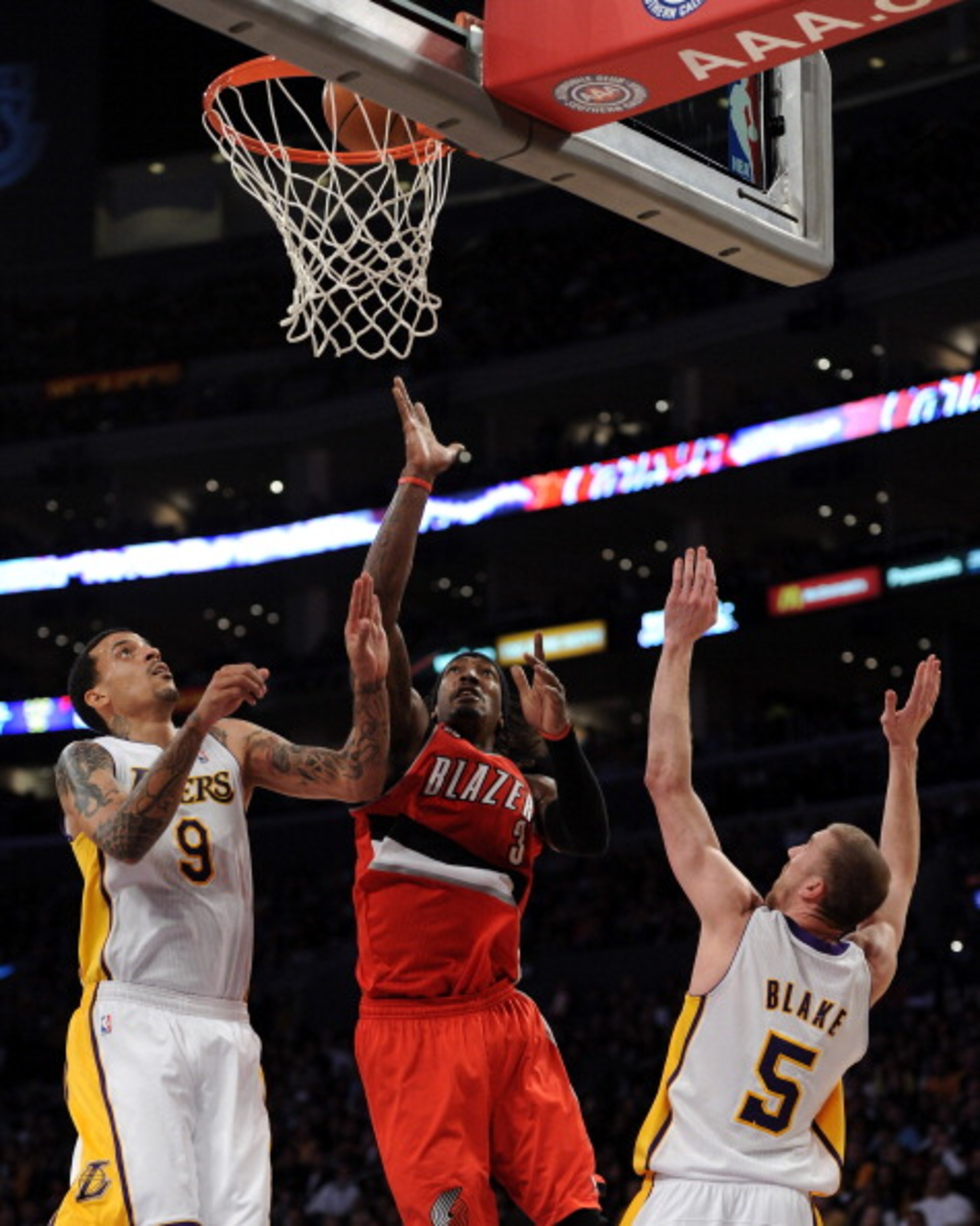 LOS ANGELES, CA - MARCH 20:  Gerald Wallace #3 of the Portland Trail Blazers scores off of a layup in front of Matt Barnes #9 and Steve Blake #5 of the Los Angeles Lakers at the Staples Center on March 20, 2011 in Los Angeles, California.  NOTE TO USER: U