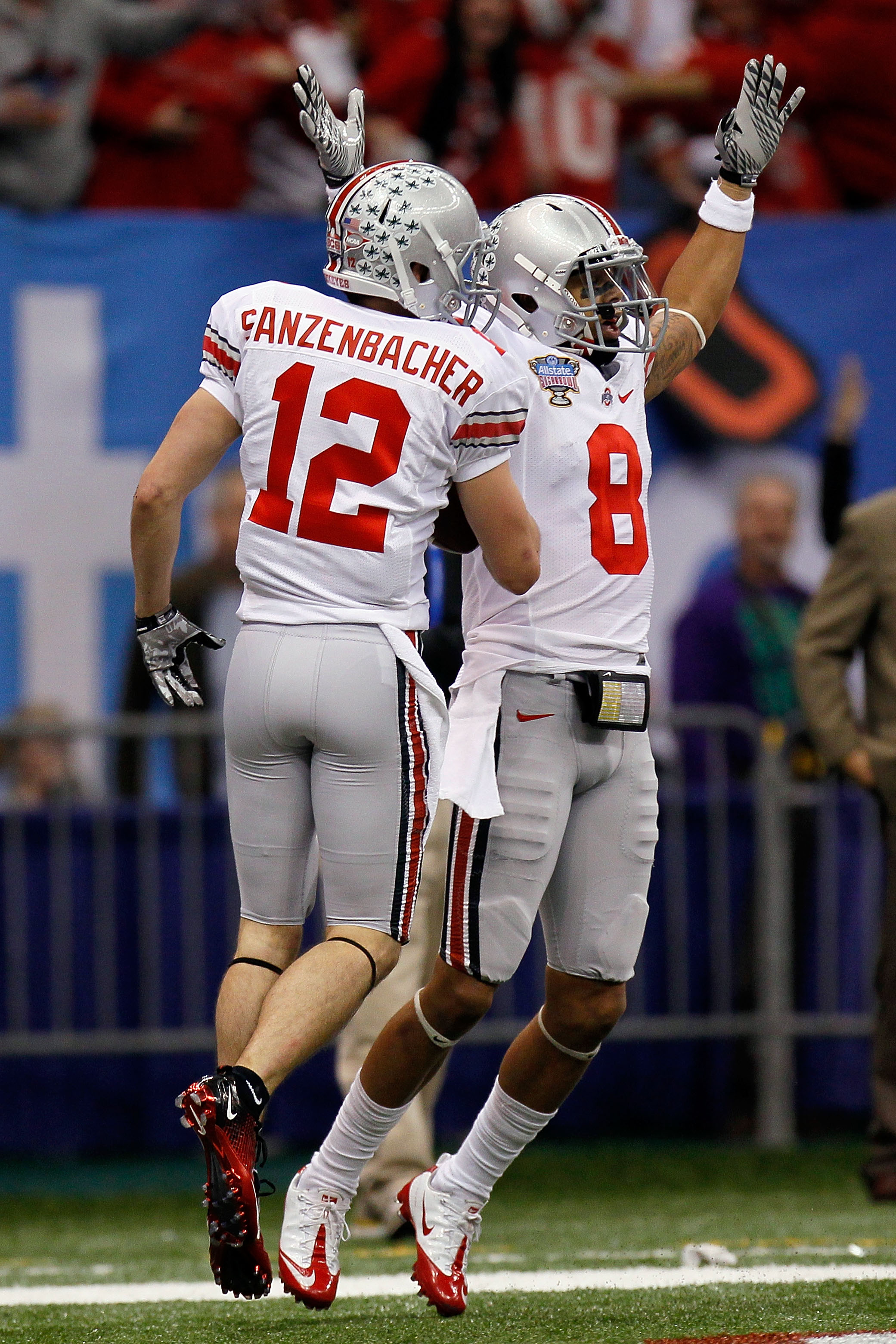 NEW ORLEANS, LA - JANUARY 04:  DeVier Posey #8 and Dane Sanzenbacher #12 of the Ohio State Buckeyes celebrate Sanzenbachers touchdown on a fumble recovery in the first quarter against the Arkansas Razorbacks during the Allstate Sugar Bowl at the Louisiana