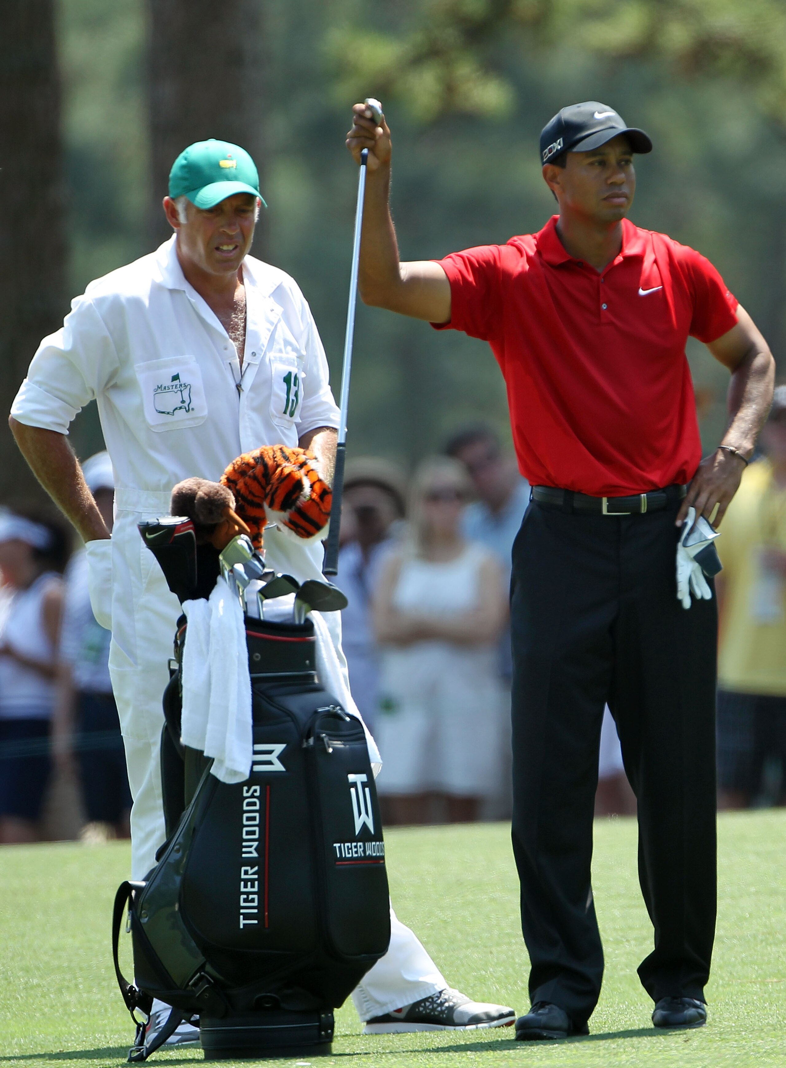 AUGUSTA, GA - APRIL 10:  Tiger Woods pulls a club in the first fairway as his caddie Steve Williams looks on during the final round of the 2011 Masters Tournament at Augusta National Golf Club on April 10, 2011 in Augusta, Georgia.  (Photo by Jamie Squire