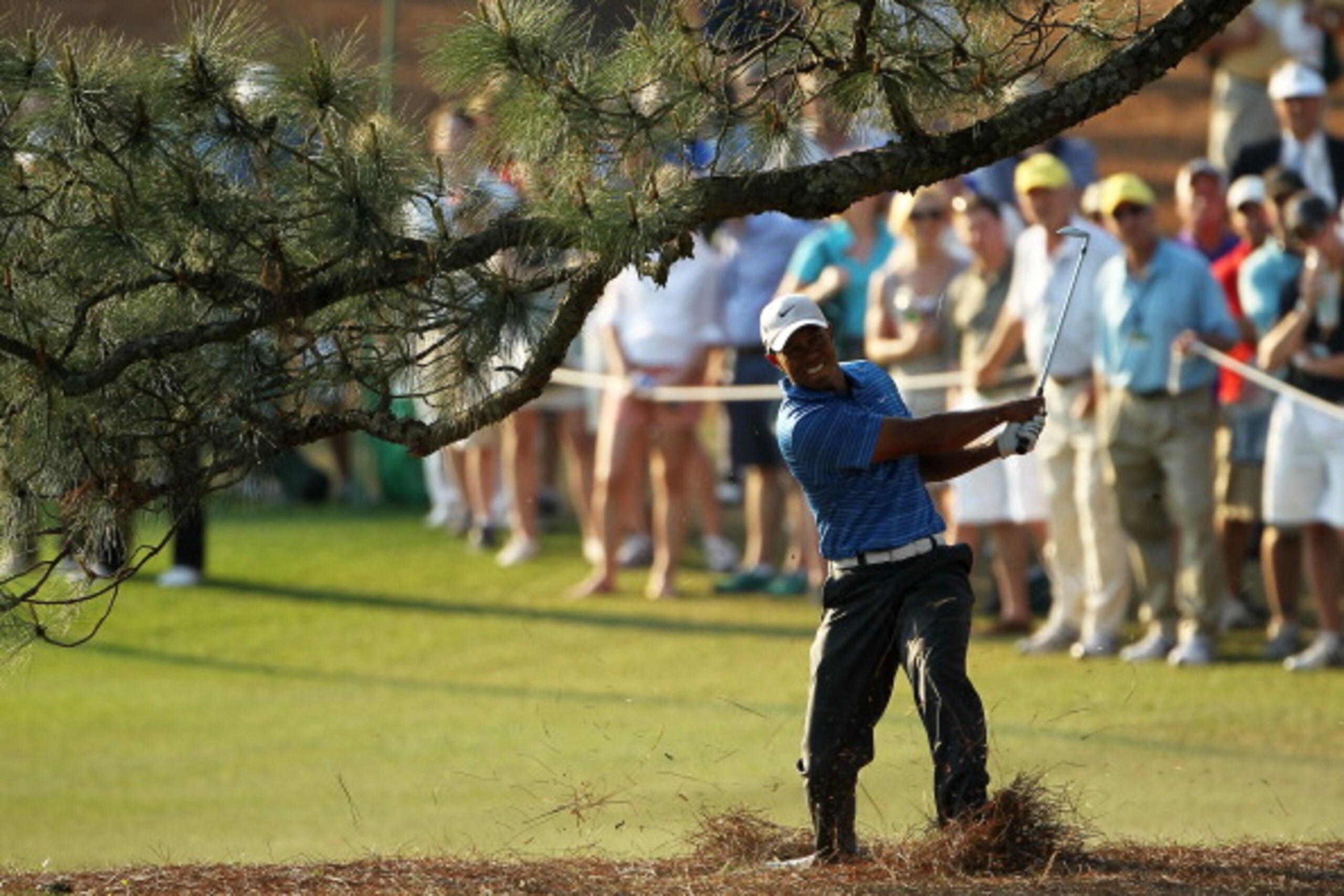 AUGUSTA, GA - APRIL 09:  Tiger Woods hits a shot from the pine needles on the 17th hole during the third round of the 2011 Masters Tournament at Augusta National Golf Club on April 9, 2011 in Augusta, Georgia.  (Photo by Jamie Squire/Getty Images)