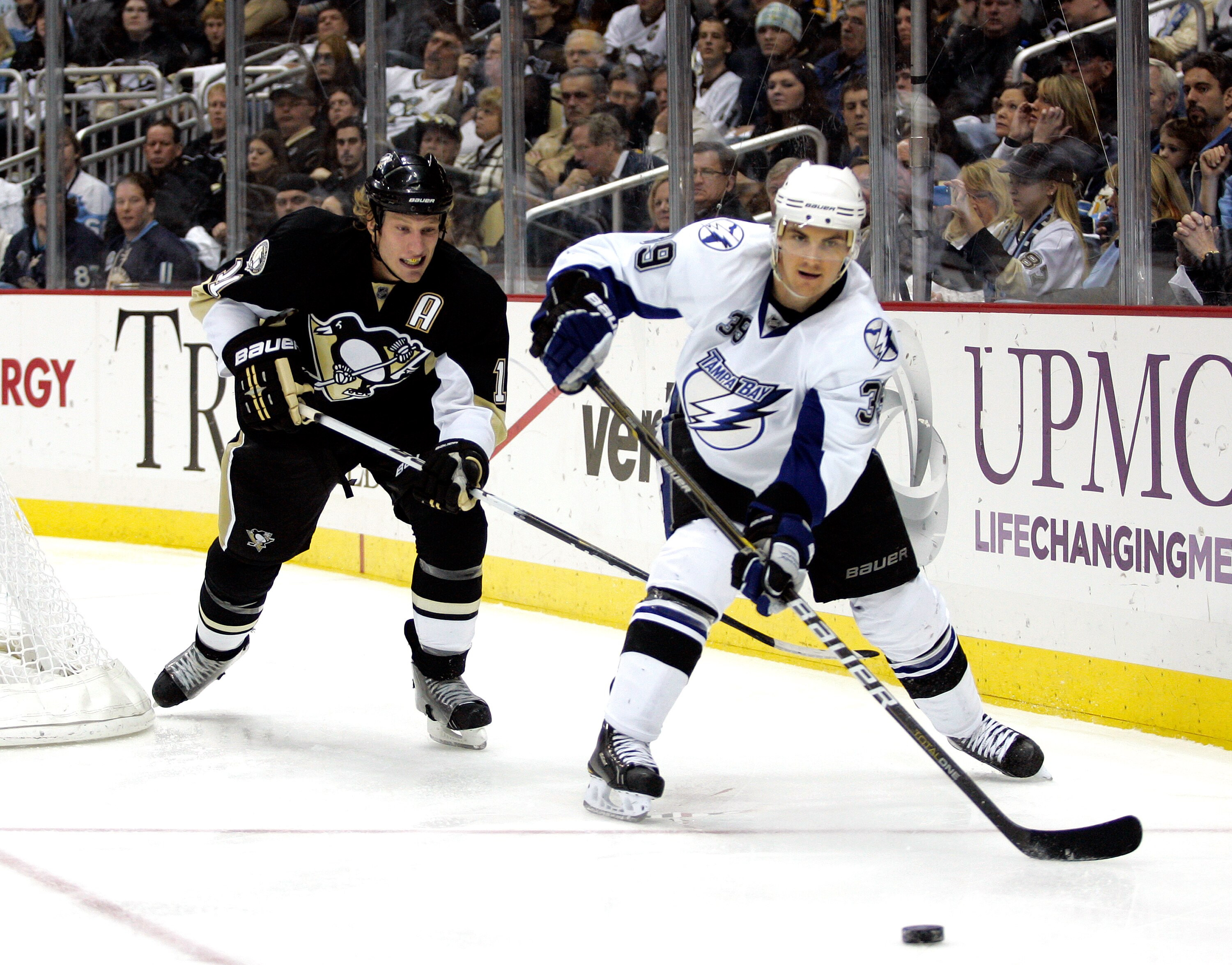PITTSBURGH, PA - JANUARY 05:  Mike Lundin #39 of the Tampa Bay Lightning and Jordan Staal #11 of the Pittsburgh Penguins battle for a puck on January 5, 2011 at Consol Energy Center in Pittsburgh, Pennsylvania.  (Photo by Justin K. Aller/Getty Images)