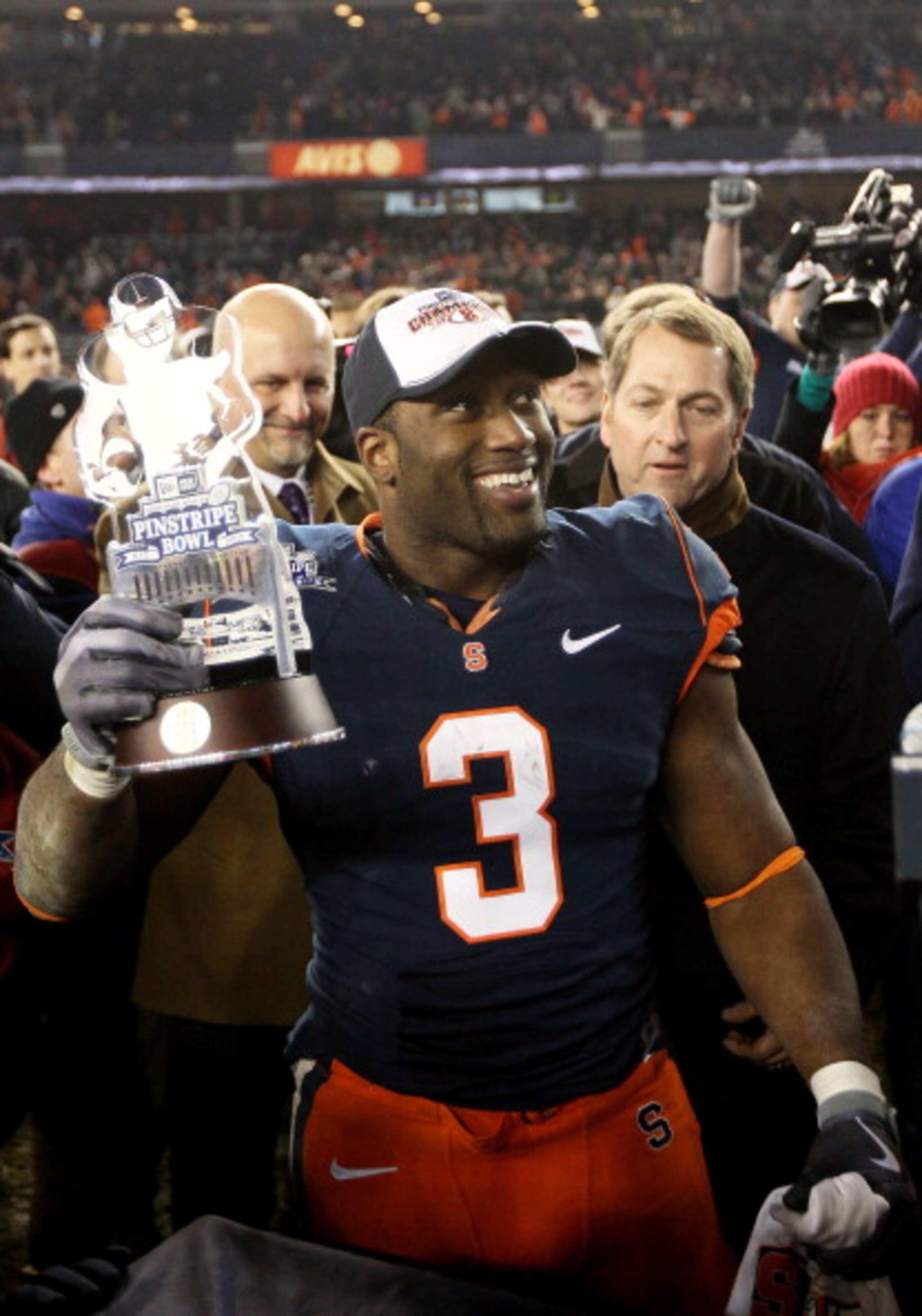 NEW YORK, NY - DECEMBER 30: Delone Carter #3 of the Syracuse Orange celebrates winning the MVP trophy after defeating the Kansas State Wildcats during the New Era Pinstripe Bowl at Yankee Stadium on December 30, 2010 in New York, New York. (Photo by Chri NEW YORK, NY - DECEMBER 30: Delone Carter #3 of the Syracuse Orange celebrates winning the MVP trophy after defeating the Kansas State Wildcats during the New Era Pinstripe Bowl at Yankee Stadium on December 30, 2010 in New York, New York. (Photo by Chri