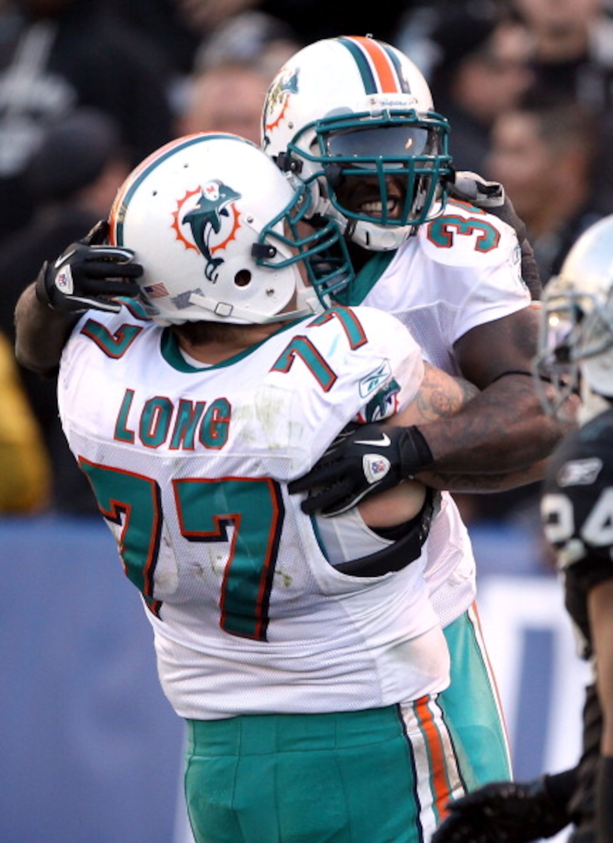 OAKLAND, CA - NOVEMBER 28: Ricky Williams #34 of the Miami Dolphins celebrates with Jake Long #77 after Williams scored a touchdown during their game against the Oakland Raiders at Oakland-Alameda County Coliseum on November 28, 2010 in Oakland, Californ OAKLAND, CA - NOVEMBER 28: Ricky Williams #34 of the Miami Dolphins celebrates with Jake Long #77 after Williams scored a touchdown during their game against the Oakland Raiders at Oakland-Alameda County Coliseum on November 28, 2010 in Oakland, Californ