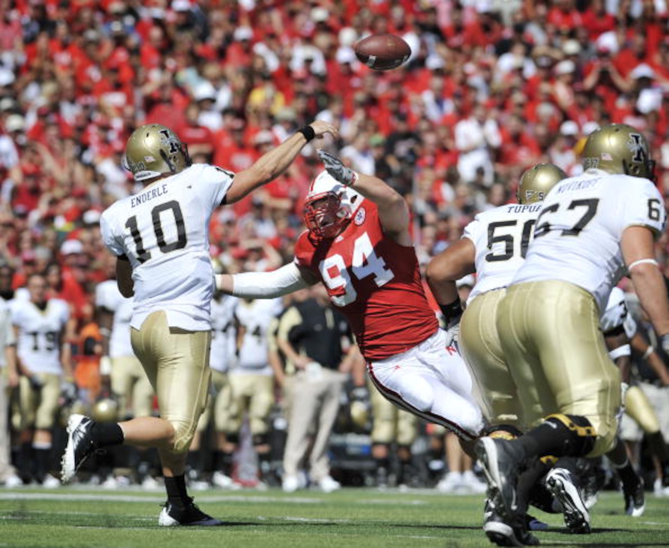 LINCOLN, NEBRASKA - SEPTEMBER 11: Idaho Vandals quarterback Nathan Enderle #10 throws a pass down field over Nebraska Cornhuskers defensive tackle Jared Crick #94 during second half action of their game at Memorial Stadium on September 4, 2010 in Lincoln,