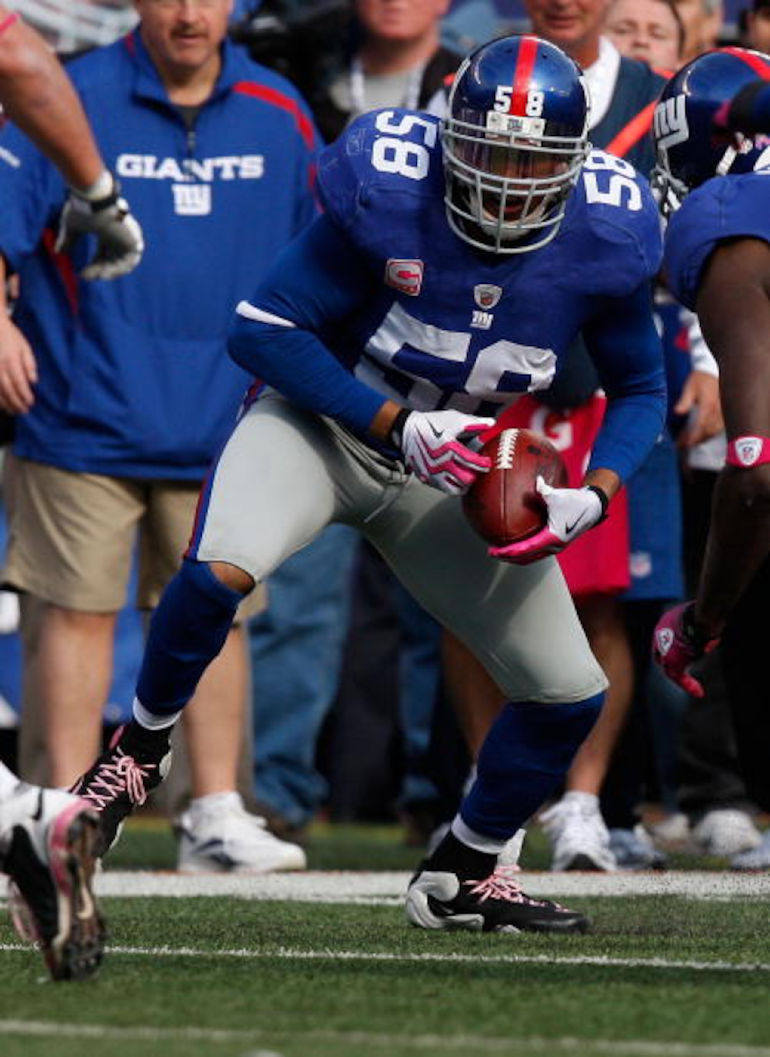 EAST RUTHERFORD, NJ - OCTOBER 11: Antonio Pierce #58 of the New York Giants runs with the ball after a fumble against the Oakland Raiders during the game on October 11, 2009 at Giants Stadium in East Rutherford, New Jersey. (Photo by Jared Wickerham/Getty