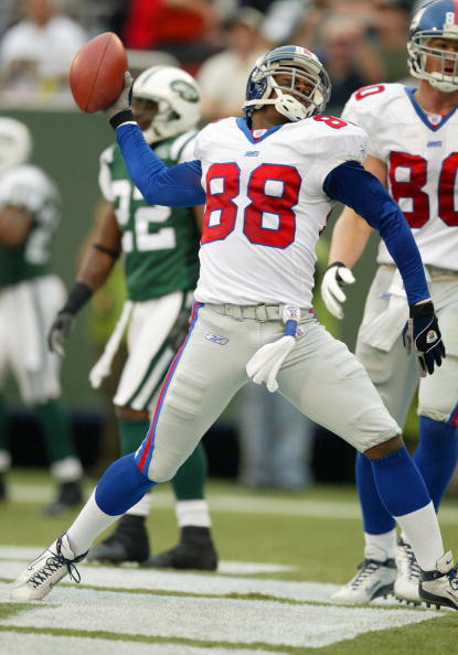 EAST RUTHERFORD, NJ - NOVEMBER 2:  Ike Hilliard #88 of the New York Giants celebrates a touchdown in the fourth quarter against the New York Jets during their game at Giants Stadium on November 2, 2003 in East Rutherford, New Jersey.  (Photo by Al Bello/G