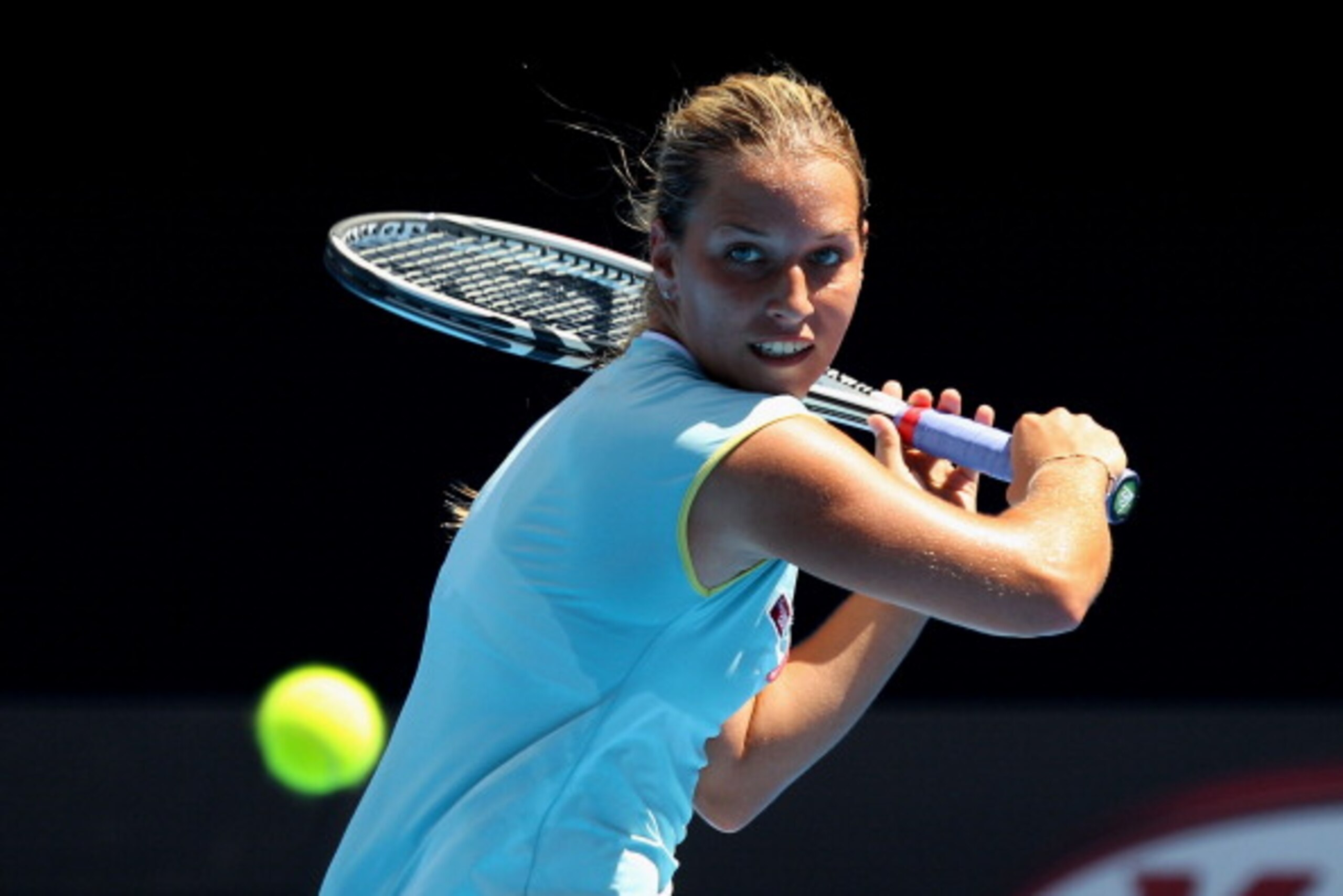 MELBOURNE, AUSTRALIA - JANUARY 21: Dominika Cibulkova of Slovakia plays a backhand in her third round match against Caroline Wozniacki of Denmark during day five of the 2011 Australian Open at Melbourne Park on January 21, 2011 in Melbourne, Australia.  (