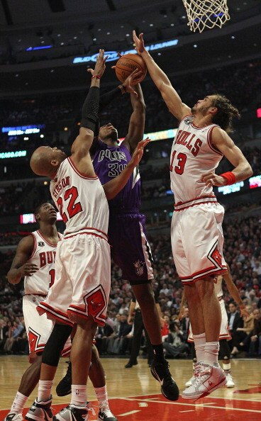 CHICAGO, IL - MARCH 21: Joakim Noah #13 of the Chicago Bulls blocks a shot by Jason Thompson #34 of the Sacramento Kings as teammate Taj Gibson #22 also defends at the United Center on March 21, 2011 in Chicago, Illinois. NOTE TO USER: User expressly ackn