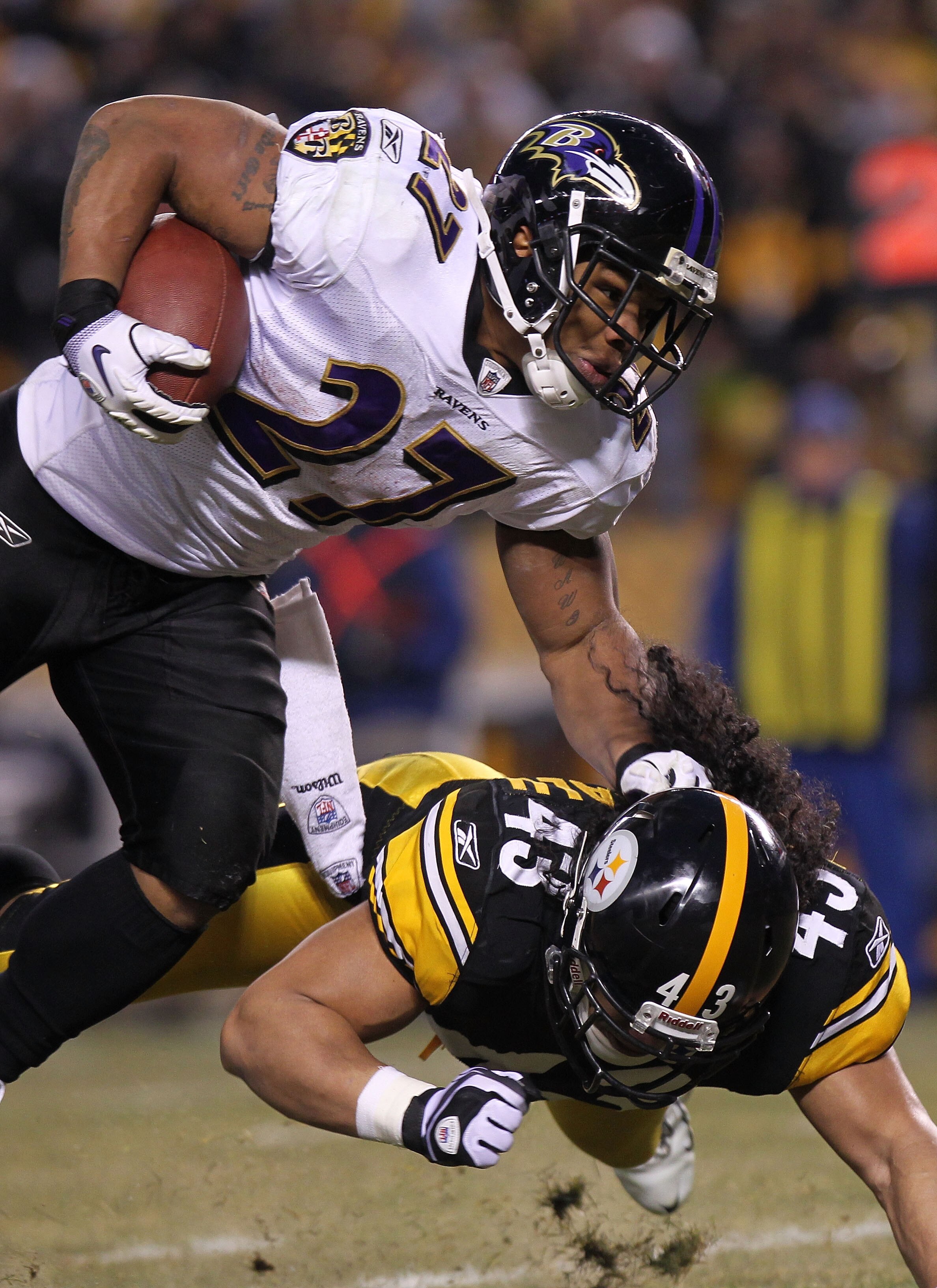 PITTSBURGH, PA - JANUARY 15:  Running back Ray Rice #27 of the Baltimore Ravens runs with the ball after being hit by safety Troy Polamalu #43 of the Pittsburgh Steelers in the AFC Divisional Playoff Game at Heinz Field on January 15, 2011 in Pittsburgh,