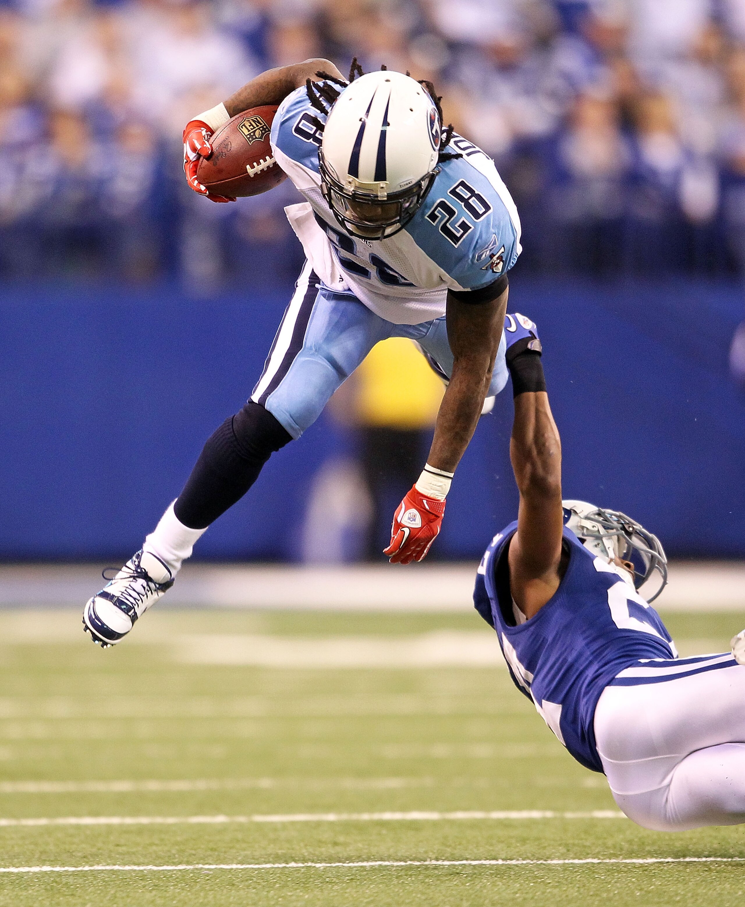 INDIANAPOLIS - JANUARY 02:  Chris Johnson #28 of the Tennessee Titans is tackled by Jacob Lacey #27 of the Indianapolis Colts at Lucas Oil Stadium on January 2, 2011 in Indianapolis, Indiana.  the Colts won 23-20.  (Photo by Andy Lyons/Getty Images)