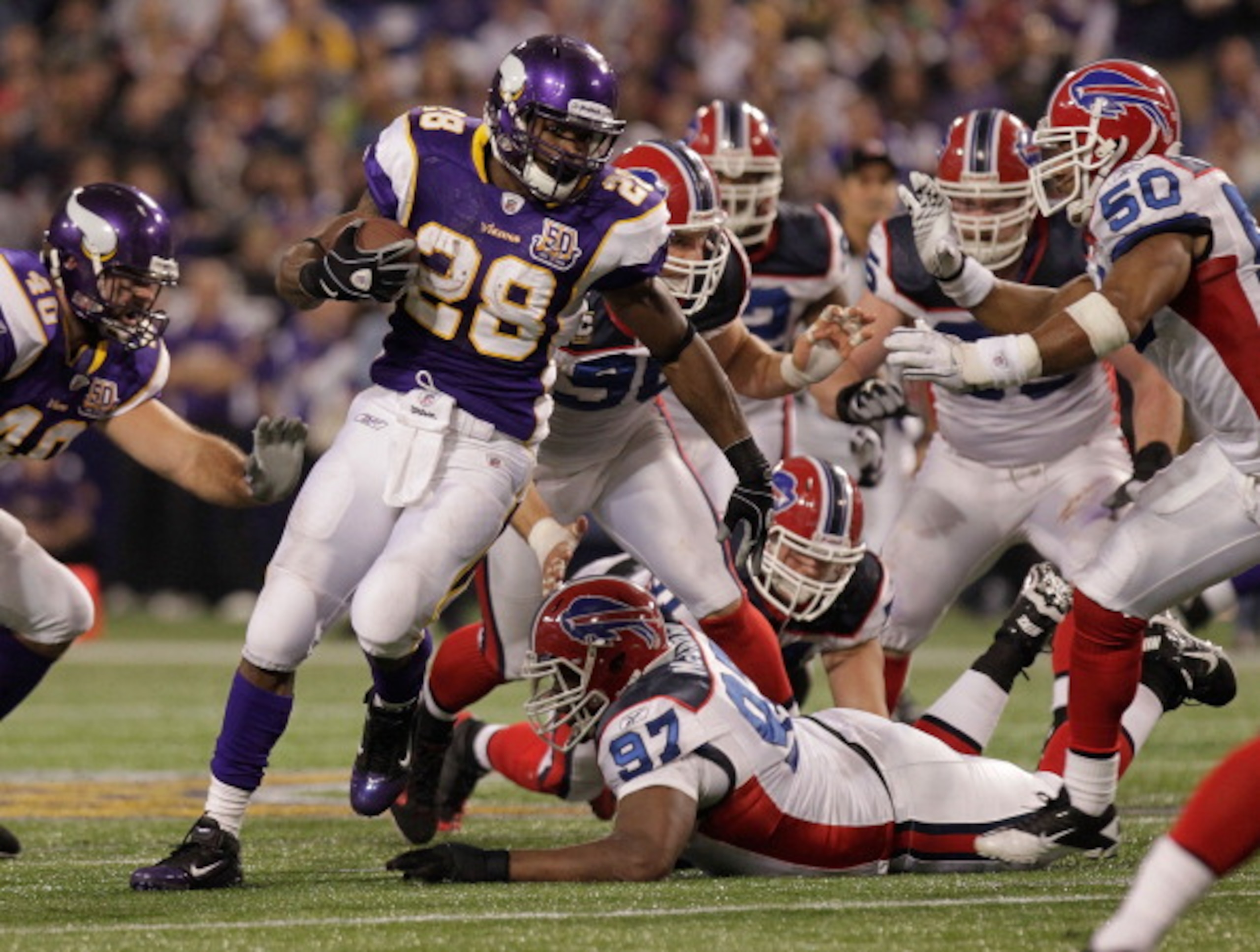 MINNEAPOLIS, MN - DECEMBER 05:  Adrian Peterson #28 of the Minnesota Vikings rushes against  the Buffalo Bills at the Mall of America Field at the Hubert H. Humphrey Metrodome on December 5, 2010 in Minneapolis, Minnesota.  (Photo by Nick Laham/Getty Imag
