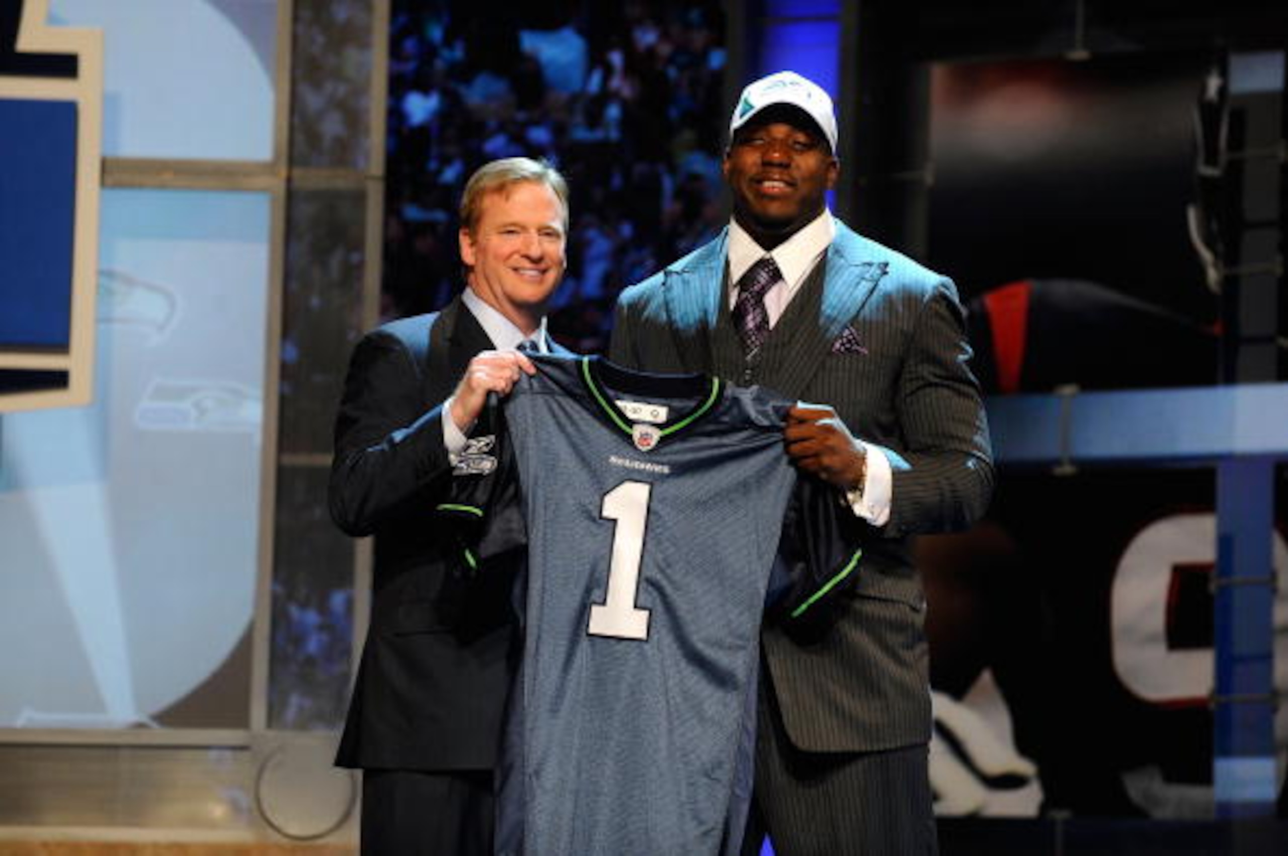 NEW YORK - APRIL 22: Russell Okung from the Oklahoma State Cowboys poses with NFL Commissioner Roger Goodell (L) as they hold a Seattle Seahawks jersey after Okung was selected number 6 overall by the Seahawks in the first round during the 2010 NFL Draft NEW YORK - APRIL 22: Russell Okung from the Oklahoma State Cowboys poses with NFL Commissioner Roger Goodell (L) as they hold a Seattle Seahawks jersey after Okung was selected number 6 overall by the Seahawks in the first round during the 2010 NFL Draft