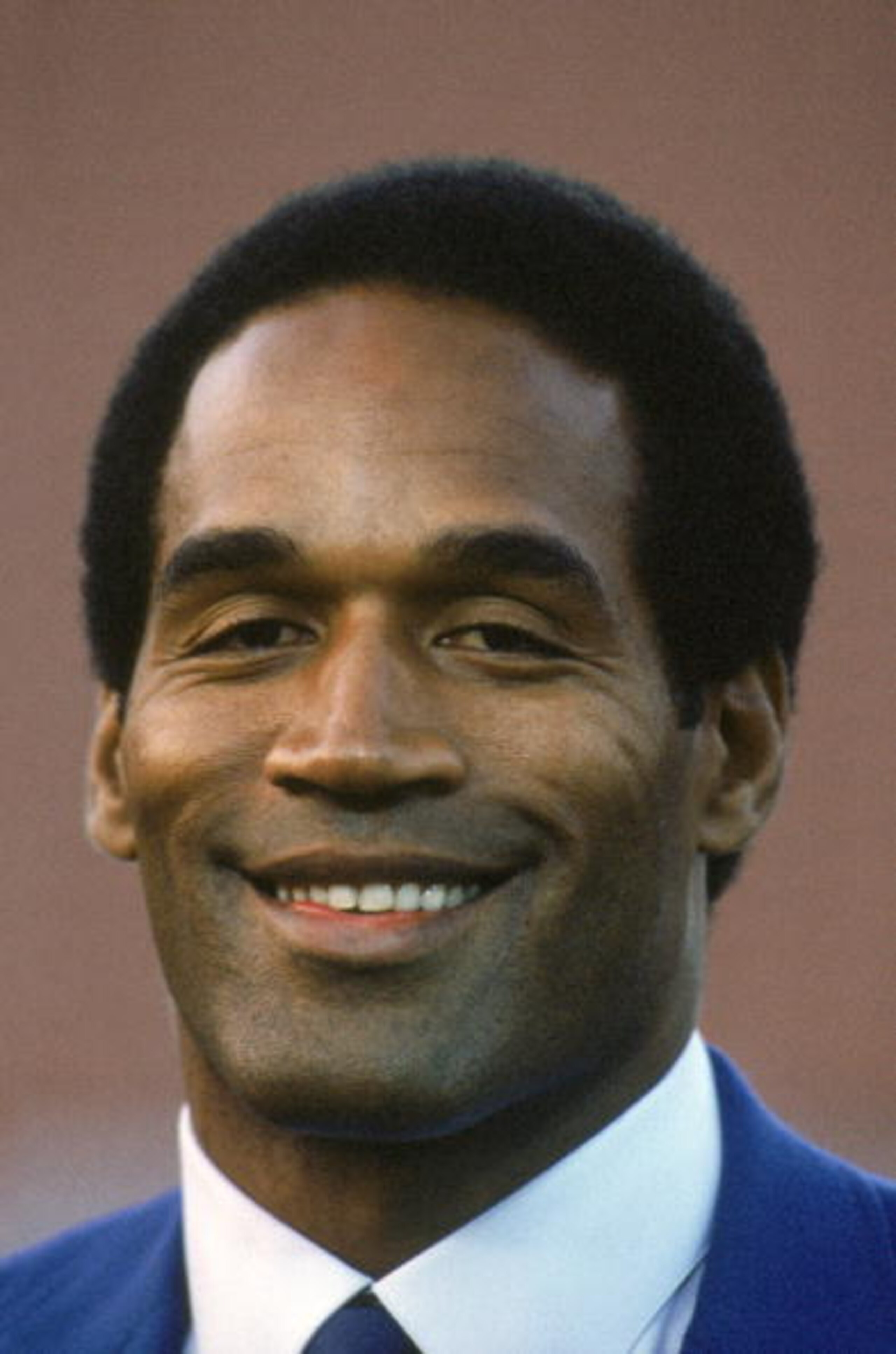 1985: NBC Analyst O.J. Simpson pose for a photo during a season game on Monday Night Football circa 1985. (Photo by George Rose/Getty Images) 1985: NBC Analyst O.J. Simpson pose for a photo during a season game on Monday Night Football circa 1985. (Photo by George Rose/Getty Images)