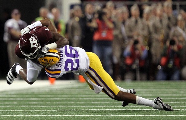 ARLINGTON, TX - JANUARY 07:  Wide receiver Brandal Jackson #4 of the Texas A&M Aggies is tackled by Tharold Simon #26 of the LSU Tigers during the AT&T Cotton Bowl at Cowboys Stadium on January 7, 2011 in Arlington, Texas.  (Photo by Ronald Martinez/Getty