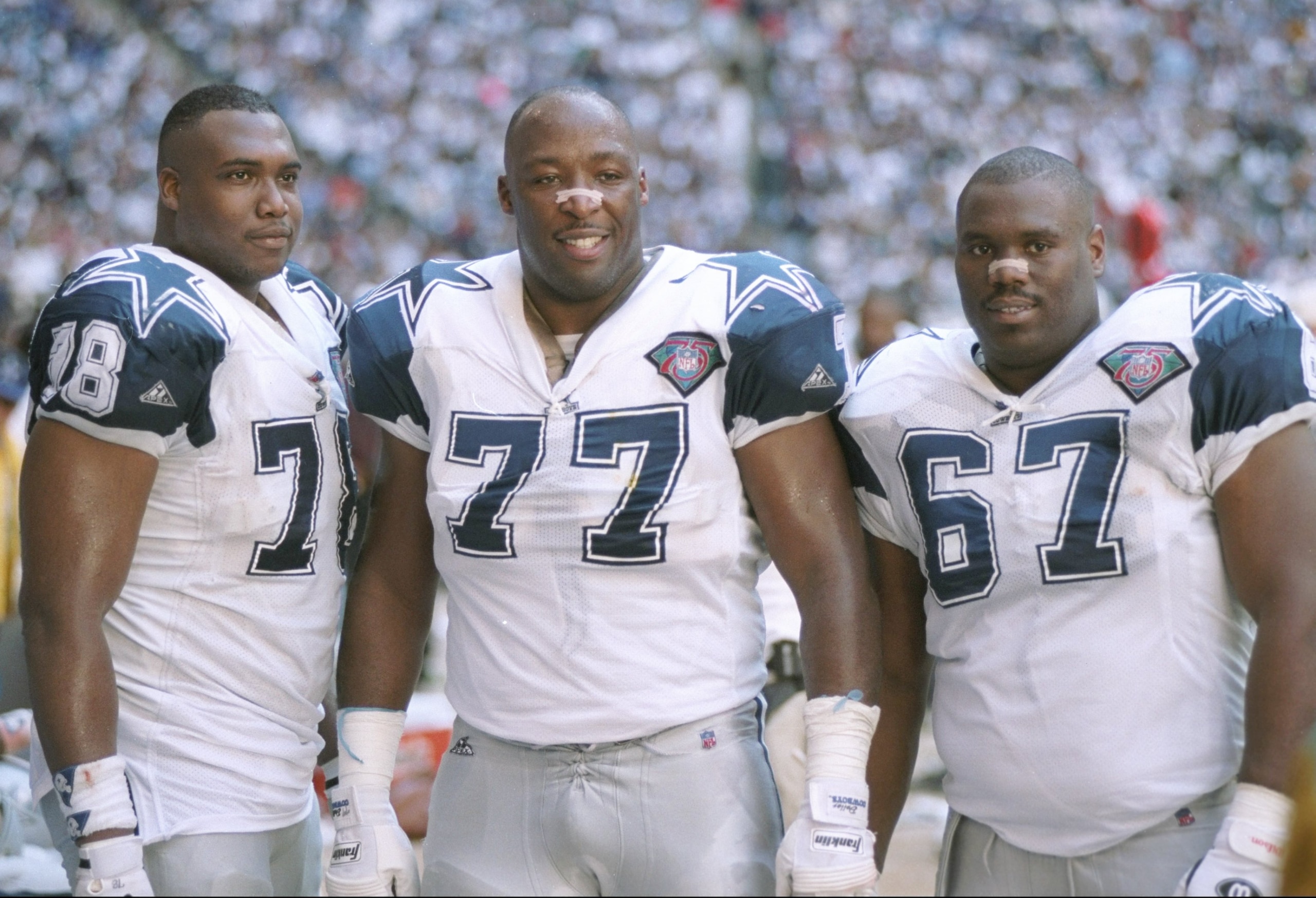 8 Jan 1995:  Dallas Cowboys defensive linemen Leon Lett, Jim Jeffcoat, and Russell Maryland (l to r) look on during a playoff game against the Green Bay Packers at Texas Stadium in Irving, Texas.  The Cowboys won the game, 35-9. Mandatory Credit: Jonathan