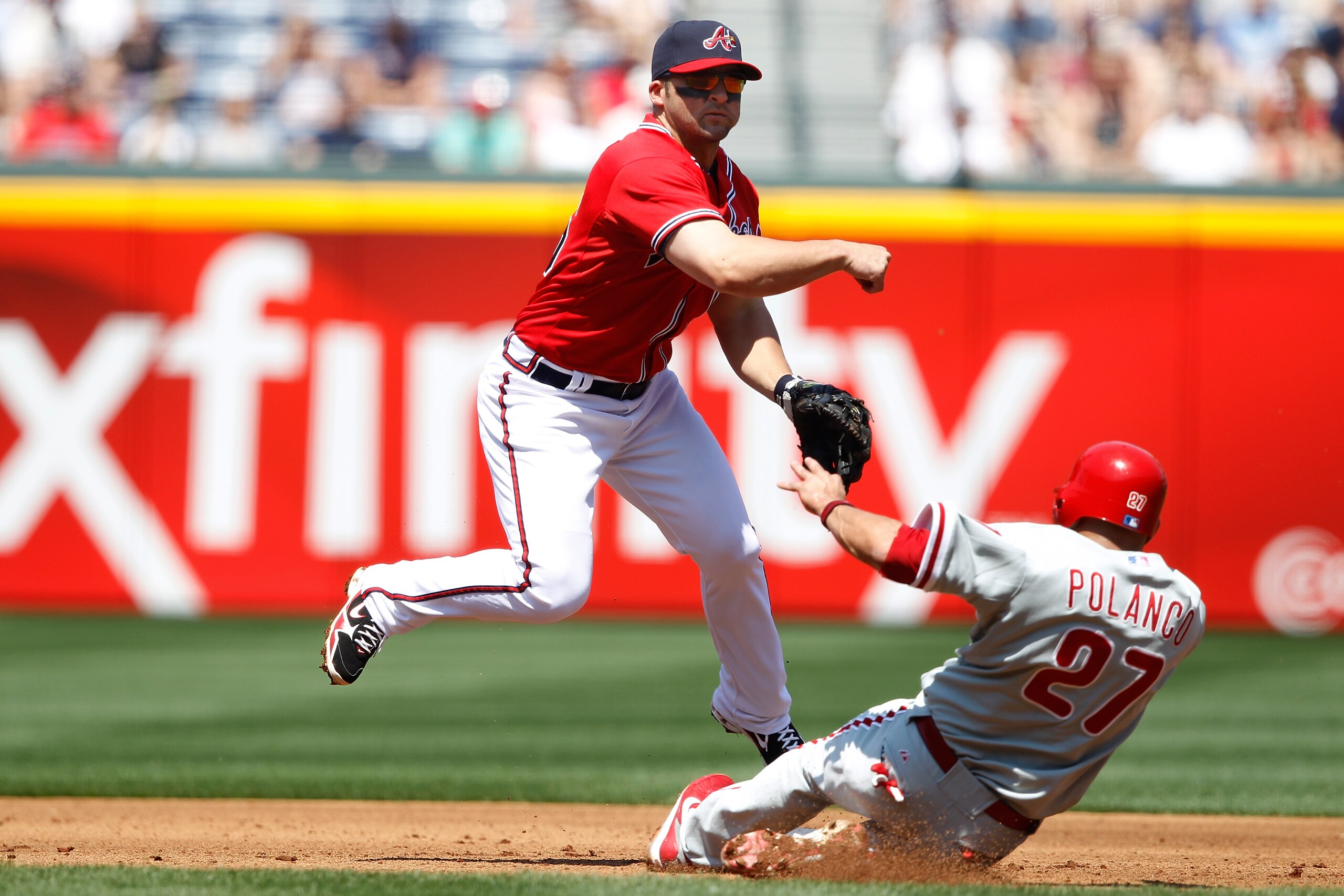 ATLANTA, GA - APRIL 10: Dan Uggla #26 of the Atlanta Braves throws to first to turn a double play over Placido Polanco #27 of the Philadelphia Phillies at Turner Field on April 10, 2011 in Atlanta, Georgia. The Phillies won 3-0. (Photo by Joe Robbins/Gett ATLANTA, GA - APRIL 10: Dan Uggla #26 of the Atlanta Braves throws to first to turn a double play over Placido Polanco #27 of the Philadelphia Phillies at Turner Field on April 10, 2011 in Atlanta, Georgia. The Phillies won 3-0. (Photo by Joe Robbins/Gett
