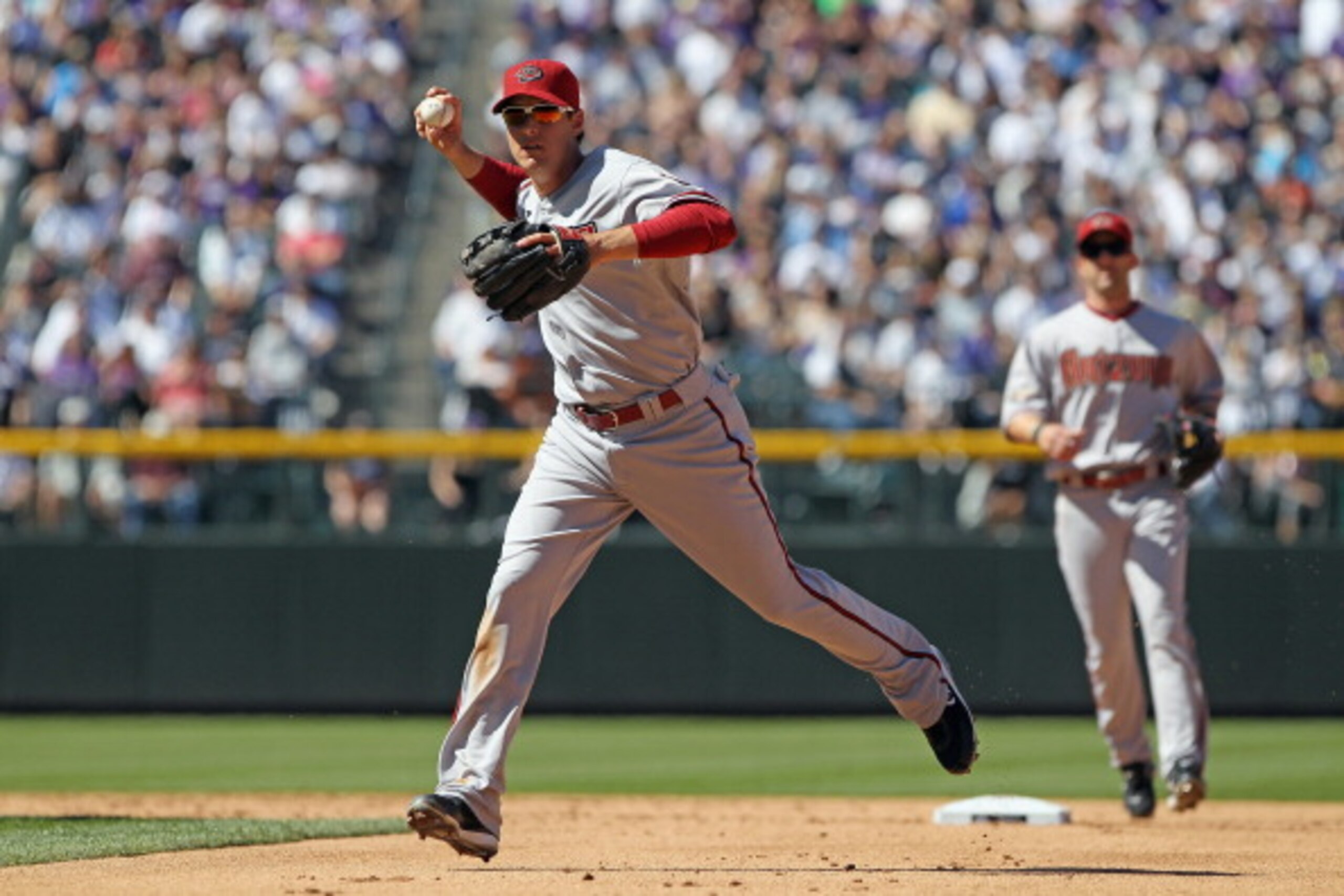 DENVER, CO - APRIL 01:  Second baseman Kelly Johnson #2 of the Arizona Diamondbacks throws out a runner against the Colorado Rockies during Opening Day at Coors Field on April 1, 2011 in Denver, Colorado. The Diamondbacks defeated the Rockies 7-6 in 11 in
