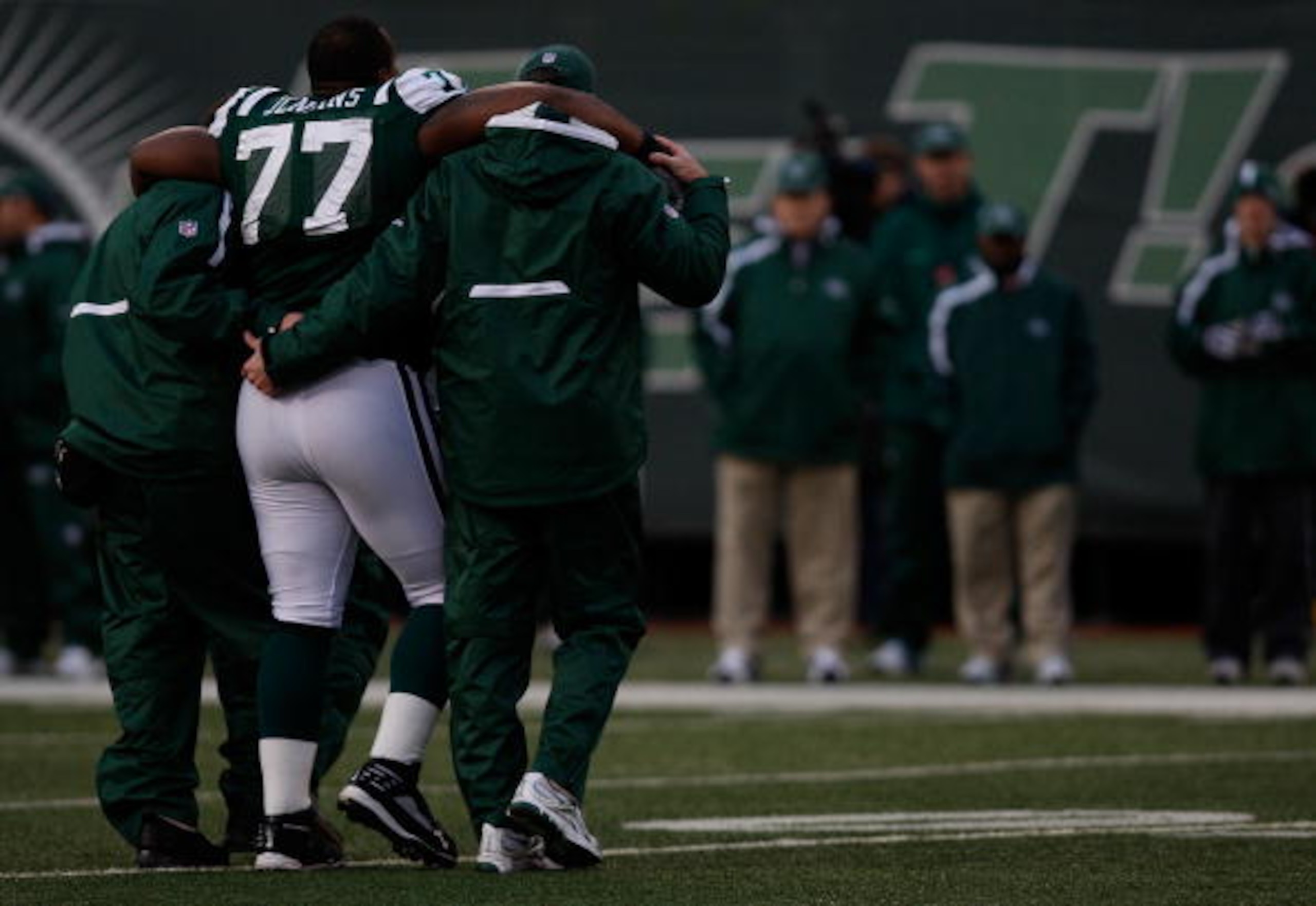 EAST RUTHERFORD, NJ - OCTOBER 18: Kris Jenkins #77 of the New York Jets walks off the field with an injury with help from the medical staff against the Buffalo Bills during the game on October 18, 2009 at Giants Stadium in East Rutherford, New Jersey. The EAST RUTHERFORD, NJ - OCTOBER 18: Kris Jenkins #77 of the New York Jets walks off the field with an injury with help from the medical staff against the Buffalo Bills during the game on October 18, 2009 at Giants Stadium in East Rutherford, New Jersey. The