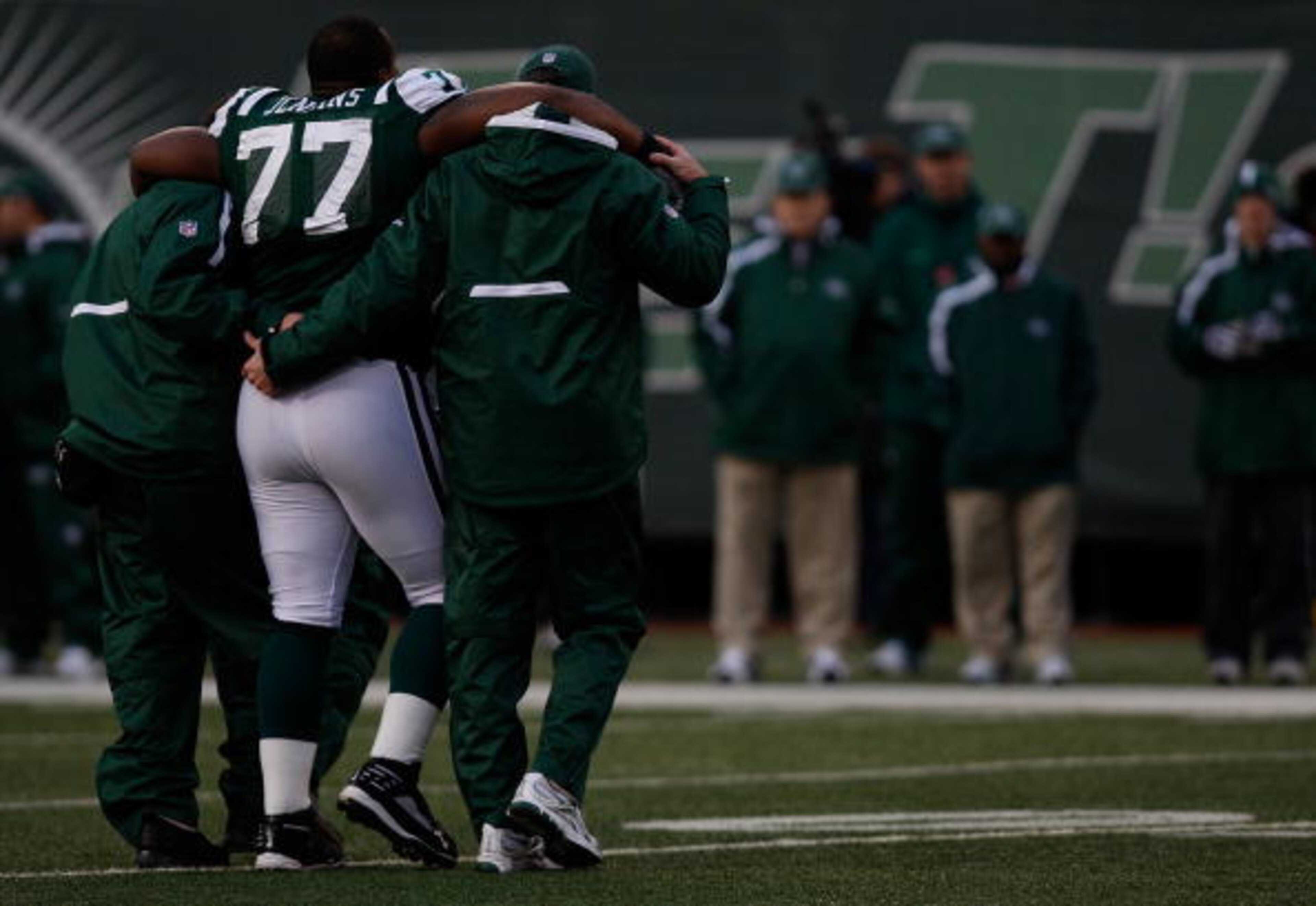 EAST RUTHERFORD, NJ - OCTOBER 18: Kris Jenkins #77 of the New York Jets walks off the field with an injury with help from the medical staff against the Buffalo Bills during the game on October 18, 2009 at Giants Stadium in East Rutherford, New Jersey. The