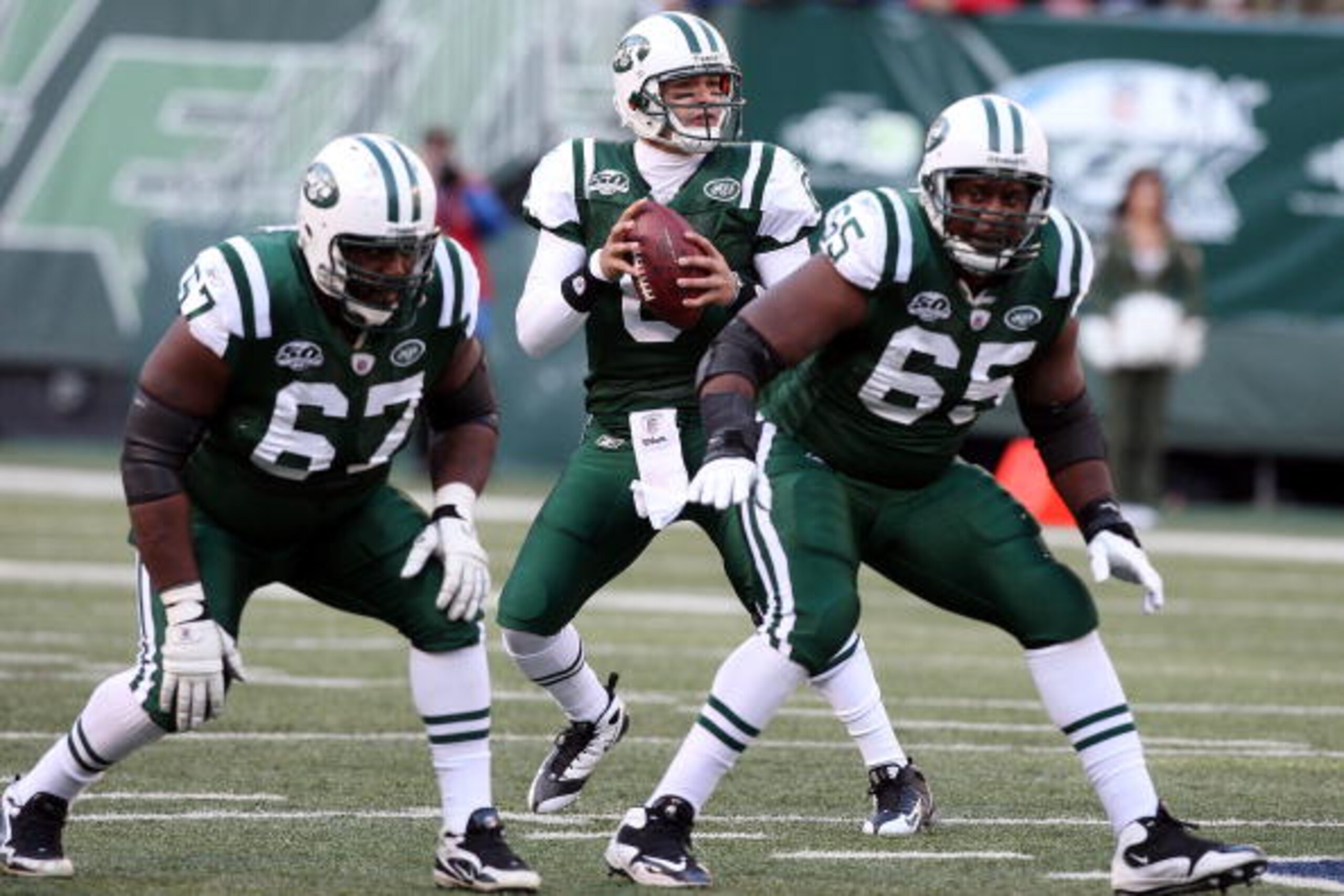 EAST RUTHERFORD, NJ - NOVEMBER 29: Mark Sanchez #6 of the New York Jets looks to throw a pass against the Carolina Panthers as Damien Woody #67 and Brandon Moore #65 defend on November 29, 2009 at Giants Stadium in East Rutherford, New Jersey. (Photo by EAST RUTHERFORD, NJ - NOVEMBER 29: Mark Sanchez #6 of the New York Jets looks to throw a pass against the Carolina Panthers as Damien Woody #67 and Brandon Moore #65 defend on November 29, 2009 at Giants Stadium in East Rutherford, New Jersey. (Photo by