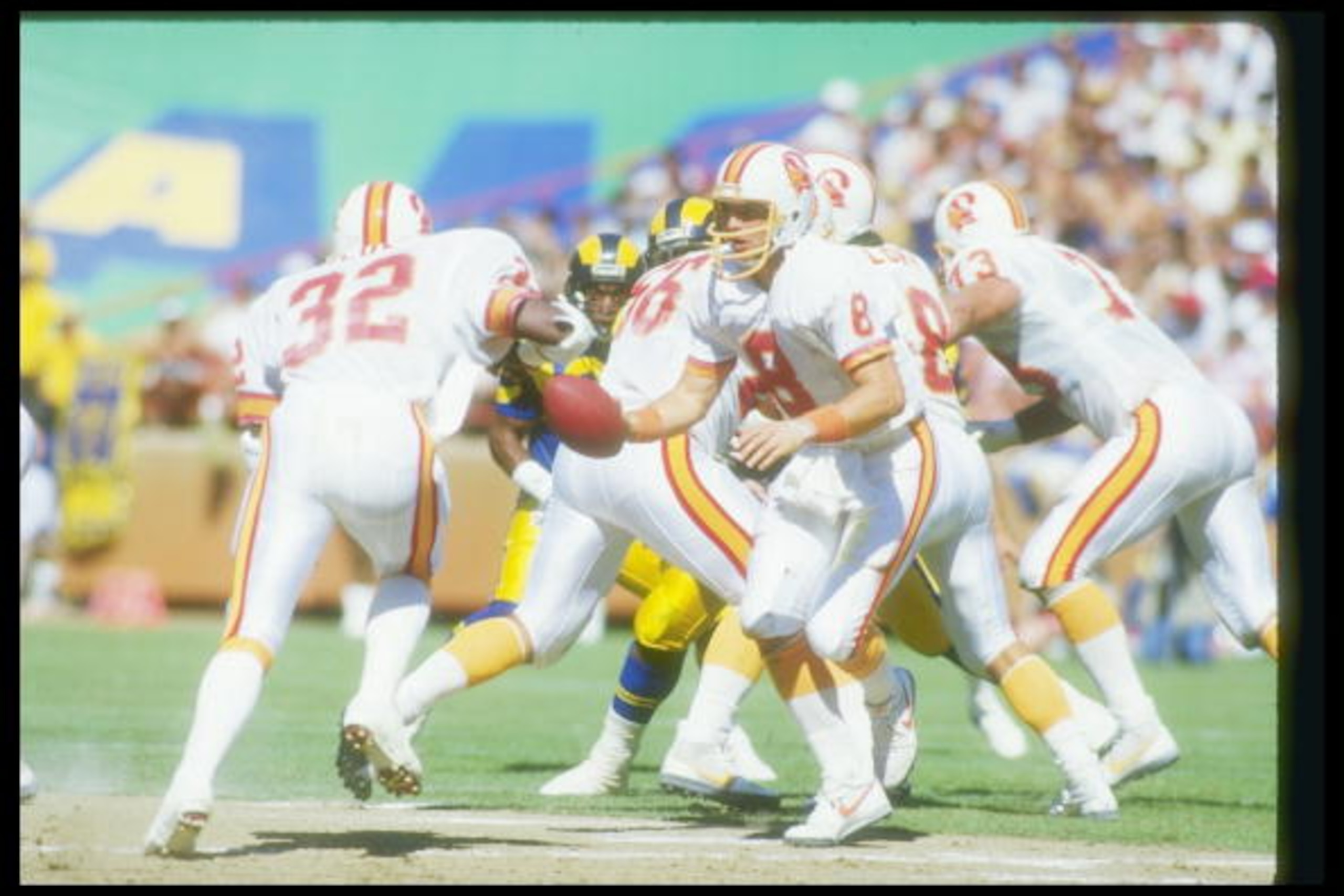 5 Oct 1986:  Quarterback Steve Young of the Tampa Bay Buccaneers looks to hand off the ball during a game against the Los Angeles Rams at Anaheim Stadium in Anaheim, California.  The Rams won the game in overtime, 26-20. Mandatory Credit: Rick Stewart  /A