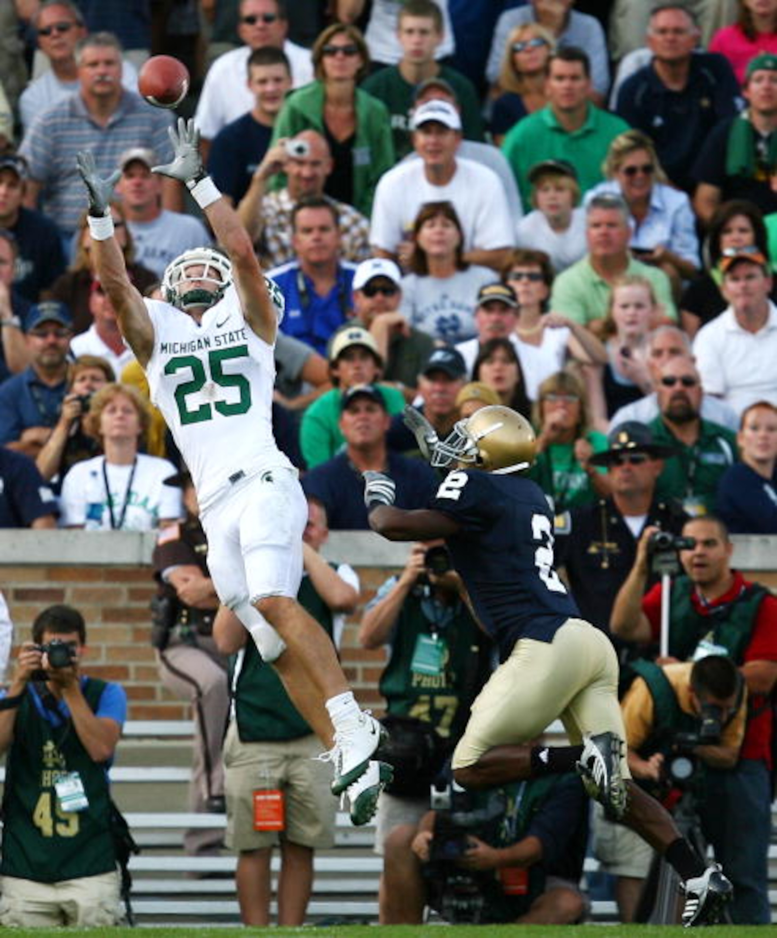 SOUTH BEND, IN - SETPEMBER 19: Blair White #25 of the Michigan State Spartans catches a touchdown pass over Darrin Walls #2 of the Notre Dame Fighting Irish on September 19, 2009 at Notre Dame Stadium in South Bend, Indiana. Notre Dame defeated Michigan S SOUTH BEND, IN - SETPEMBER 19: Blair White #25 of the Michigan State Spartans catches a touchdown pass over Darrin Walls #2 of the Notre Dame Fighting Irish on September 19, 2009 at Notre Dame Stadium in South Bend, Indiana. Notre Dame defeated Michigan S