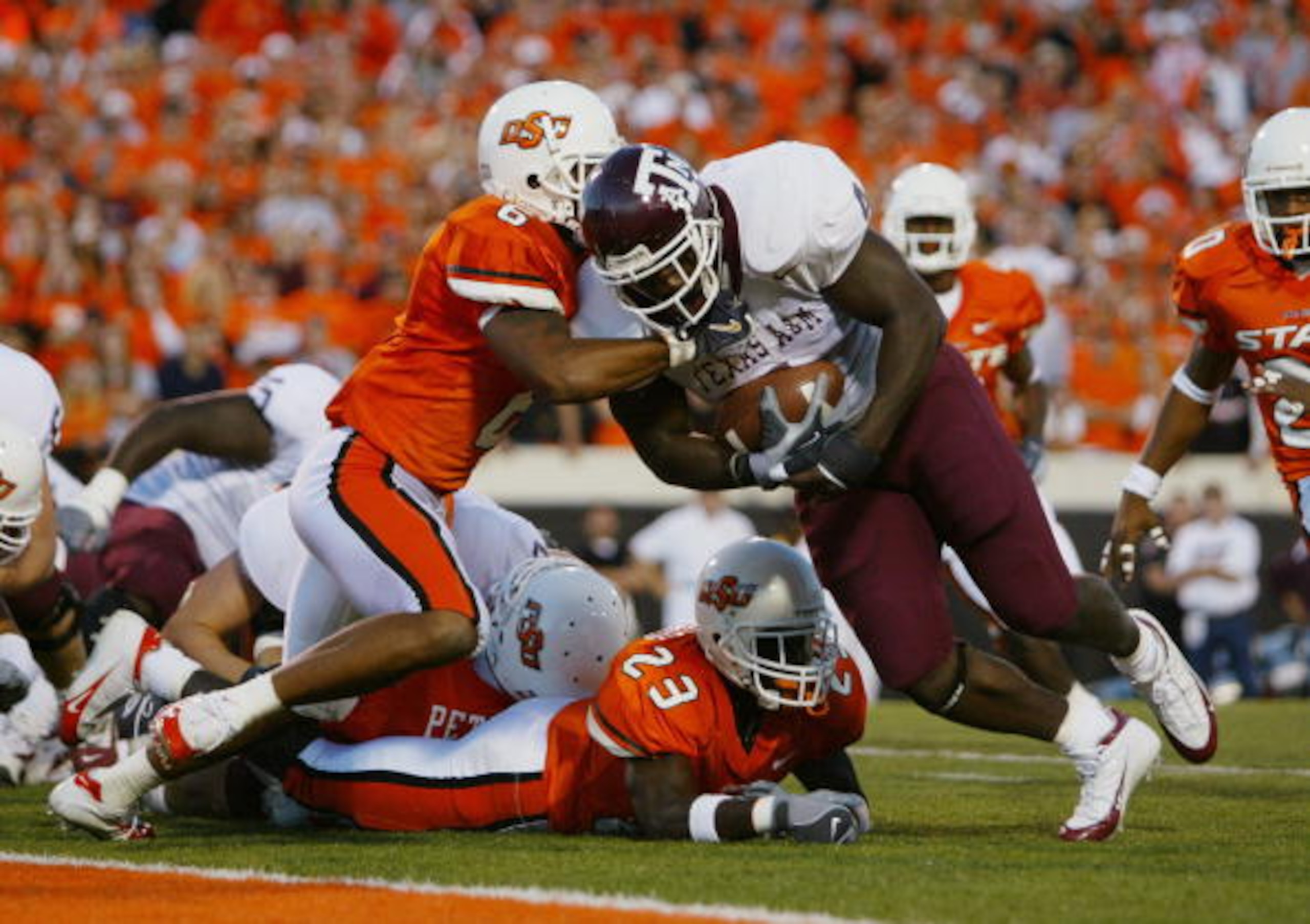 STILLWATER, OKLAHOMA - OCTOBER 16: Running back Keith Joseph #4 of the Texas A&M Aggies attempts to run through the tackle of Robert Jones #6 of the Oklahoma State Cowboys during the game at Boone Pickens Stadium on October 16, 2004 in Stillwater, Oklaho STILLWATER, OKLAHOMA - OCTOBER 16: Running back Keith Joseph #4 of the Texas A&M Aggies attempts to run through the tackle of Robert Jones #6 of the Oklahoma State Cowboys during the game at Boone Pickens Stadium on October 16, 2004 in Stillwater, Oklaho