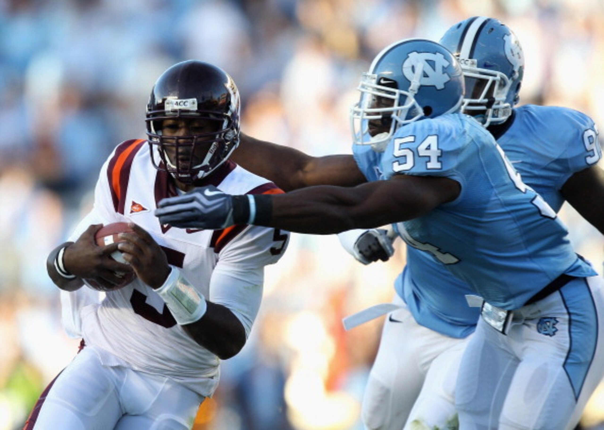 CHAPEL HILL, NC - NOVEMBER 13: Tyrod Taylor #5 of the Virginia Tech Hokies is tackled by Bruce Carter #54 and teammate Jared McAdoo #97 of the North Carolina Tar Heels during their game at Kenan Stadium on November 13, 2010 in Chapel Hill, North Carolina CHAPEL HILL, NC - NOVEMBER 13: Tyrod Taylor #5 of the Virginia Tech Hokies is tackled by Bruce Carter #54 and teammate Jared McAdoo #97 of the North Carolina Tar Heels during their game at Kenan Stadium on November 13, 2010 in Chapel Hill, North Carolina