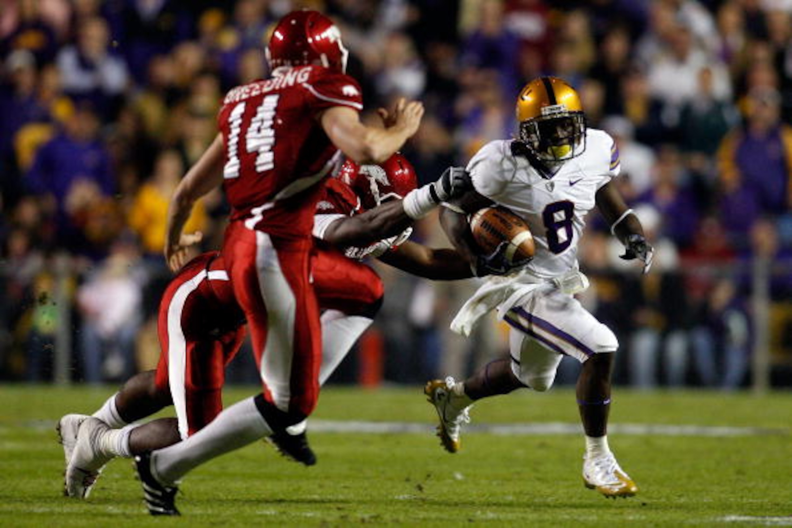 BATON ROUGE, LA - NOVEMBER 28: Trindon Holliday #8 of the Louisiana State University Tigers avoids a tackle by Ronnie Wingo Jr. #20 and Dylan Breeding #14 of the Arkansa Razorbacks at Tiger Stadium on November 28, 2009 in Baton Rouge, Louisiana. (Photo BATON ROUGE, LA - NOVEMBER 28: Trindon Holliday #8 of the Louisiana State University Tigers avoids a tackle by Ronnie Wingo Jr. #20 and Dylan Breeding #14 of the Arkansa Razorbacks at Tiger Stadium on November 28, 2009 in Baton Rouge, Louisiana. (Photo