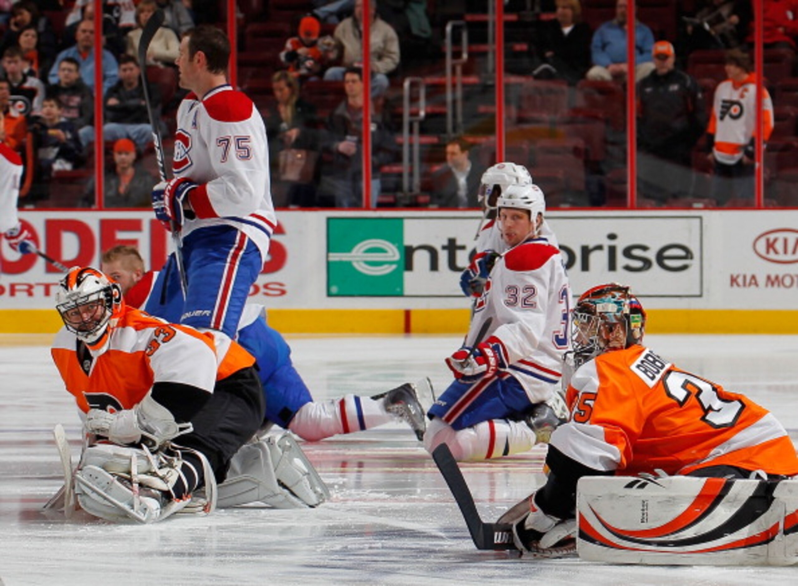 PHILADELPHIA, PA - JANUARY 25:  Goalies Sergei Bobrovsky #35 and Brian Boucher #33 of the Philadelphia Flyers stretch in front of the Montreal Canadiens during warmups before an NHL hockey game at the Wells Fargo Center on January 25, 2011 in Philadelphia