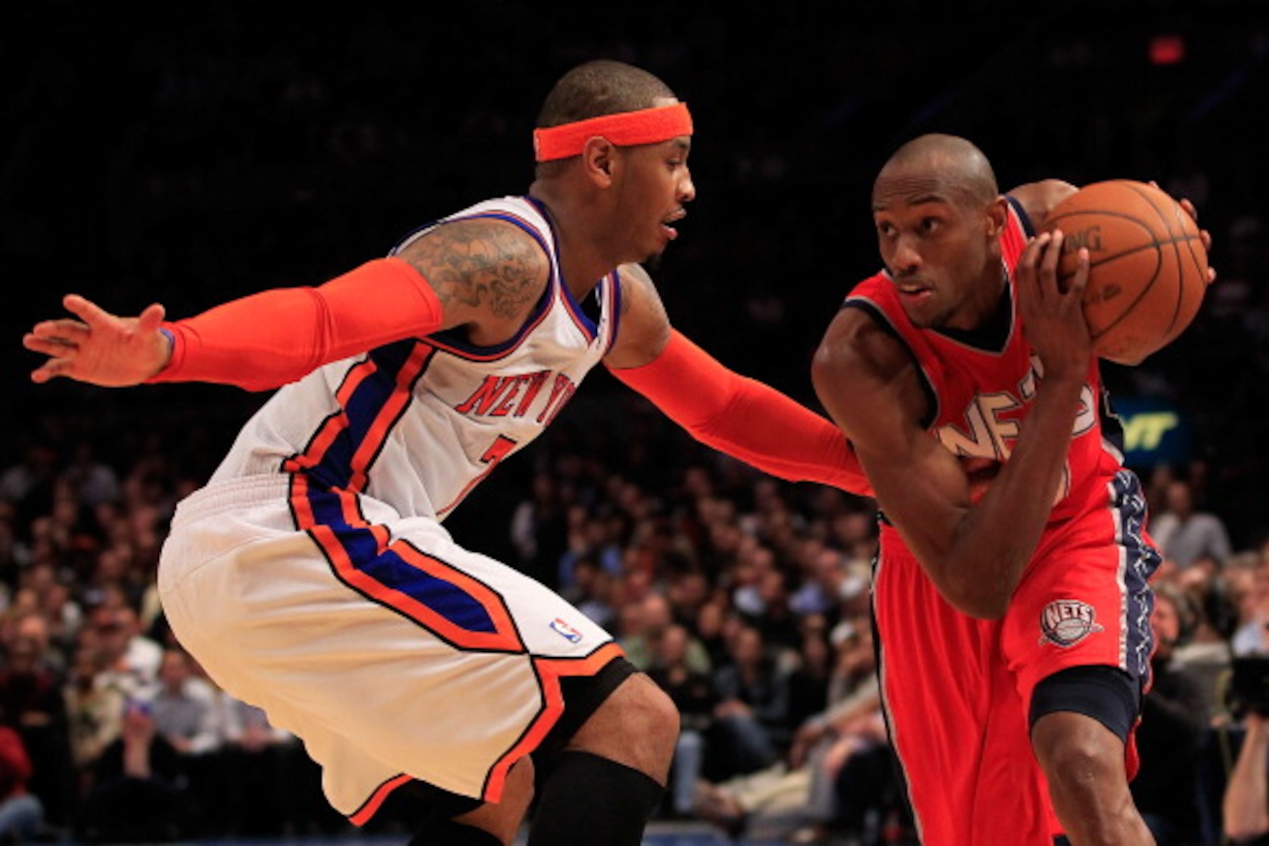NEW YORK, NY - MARCH 30: Travis Outlaw #21 of the New Jersey Nets drives against Carmelo Anthony #7 of the New York Knicks at Madison Square Garden on March 30, 2011 in New York City. NOTE TO USER: User expressly acknowledges and agrees that, by downloadi