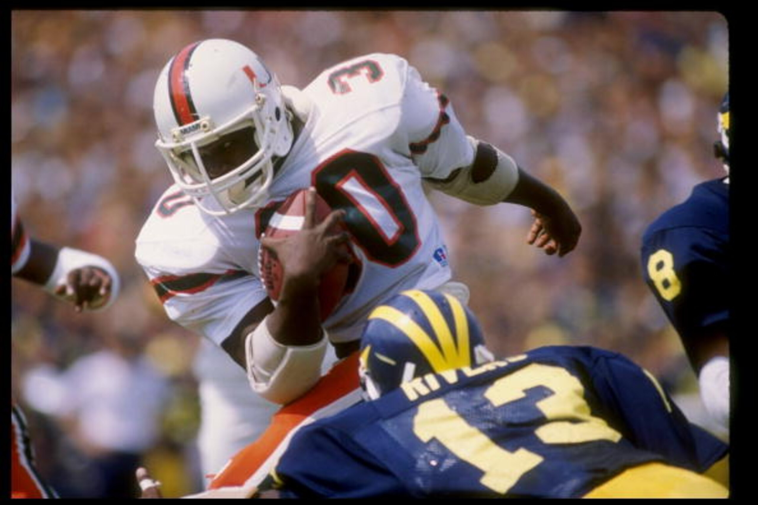 Fullback Alonzo Highsmith of the Miami Hurricanes runs with the ball during a game against the Michigan Wolverines at Michigan Stadium in Ann Arbor, Michigan.